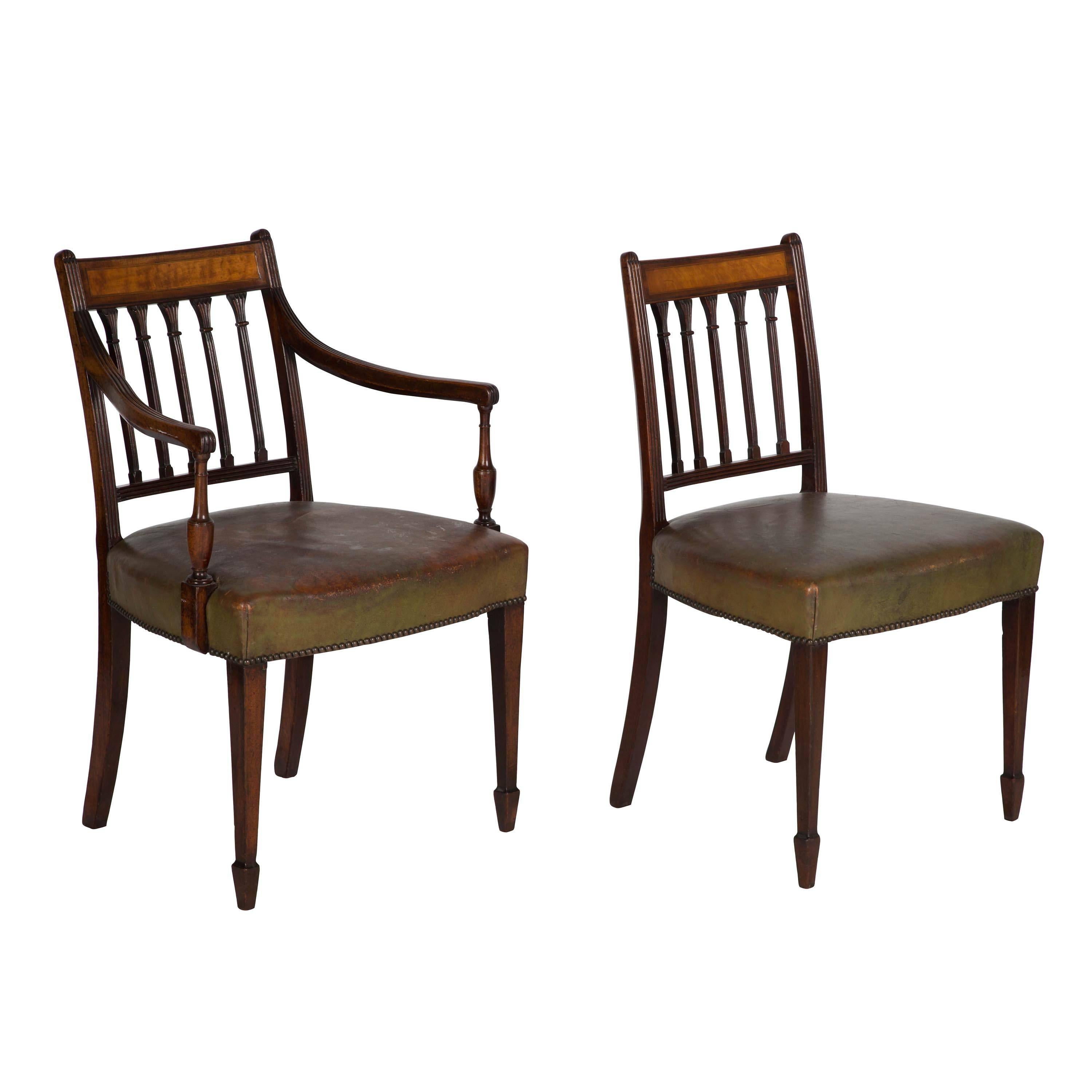 A superb set of eight George III dining chairs including two carvers with satinwood inlay to the curved bar backs.