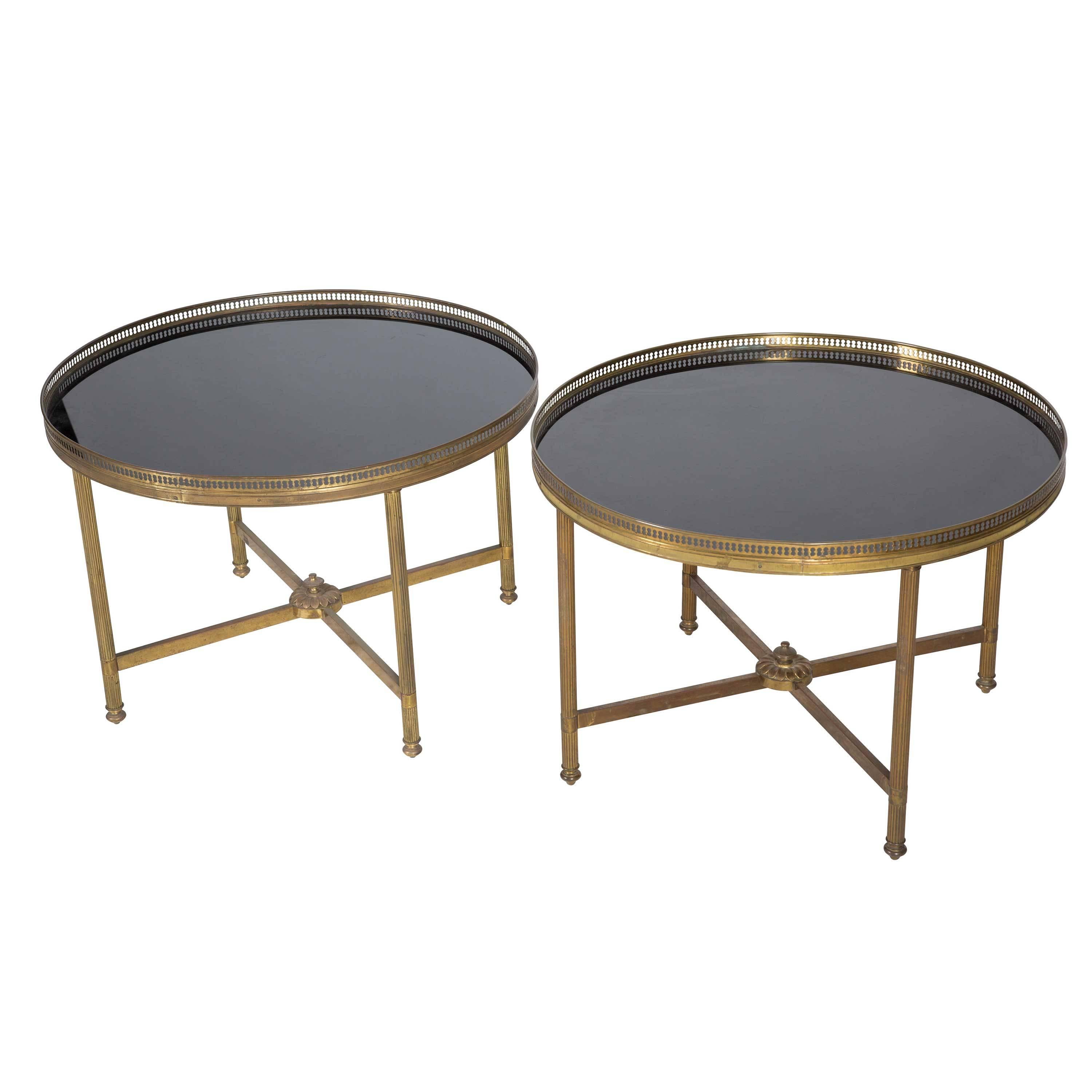 Pair of French round sofa or wine tables in brass with black glass, circa 1950.
  