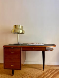 French Prouve desk in walnut, bronze, and rubber. France, 1970s.