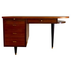 French Prouve desk in walnut, bronze, and rubber. France, 1970s.