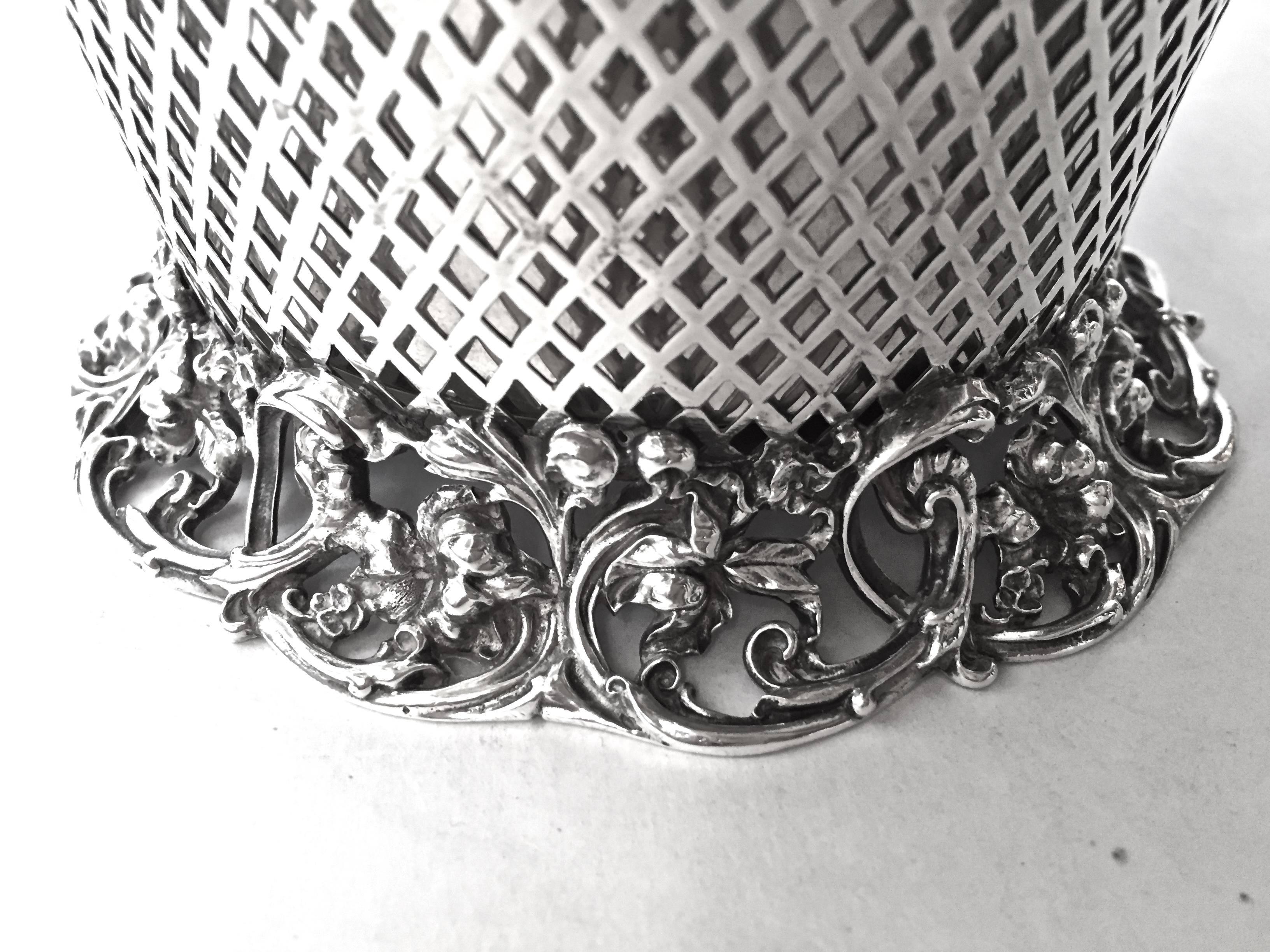 A gorgeous American Sterling Silver centerpiece basket with its original frog.
Grate for helping to arrange the flowers. The silver work is exceptional showing off several techniques with silver applied, reticulated and cast. the top boarder
and