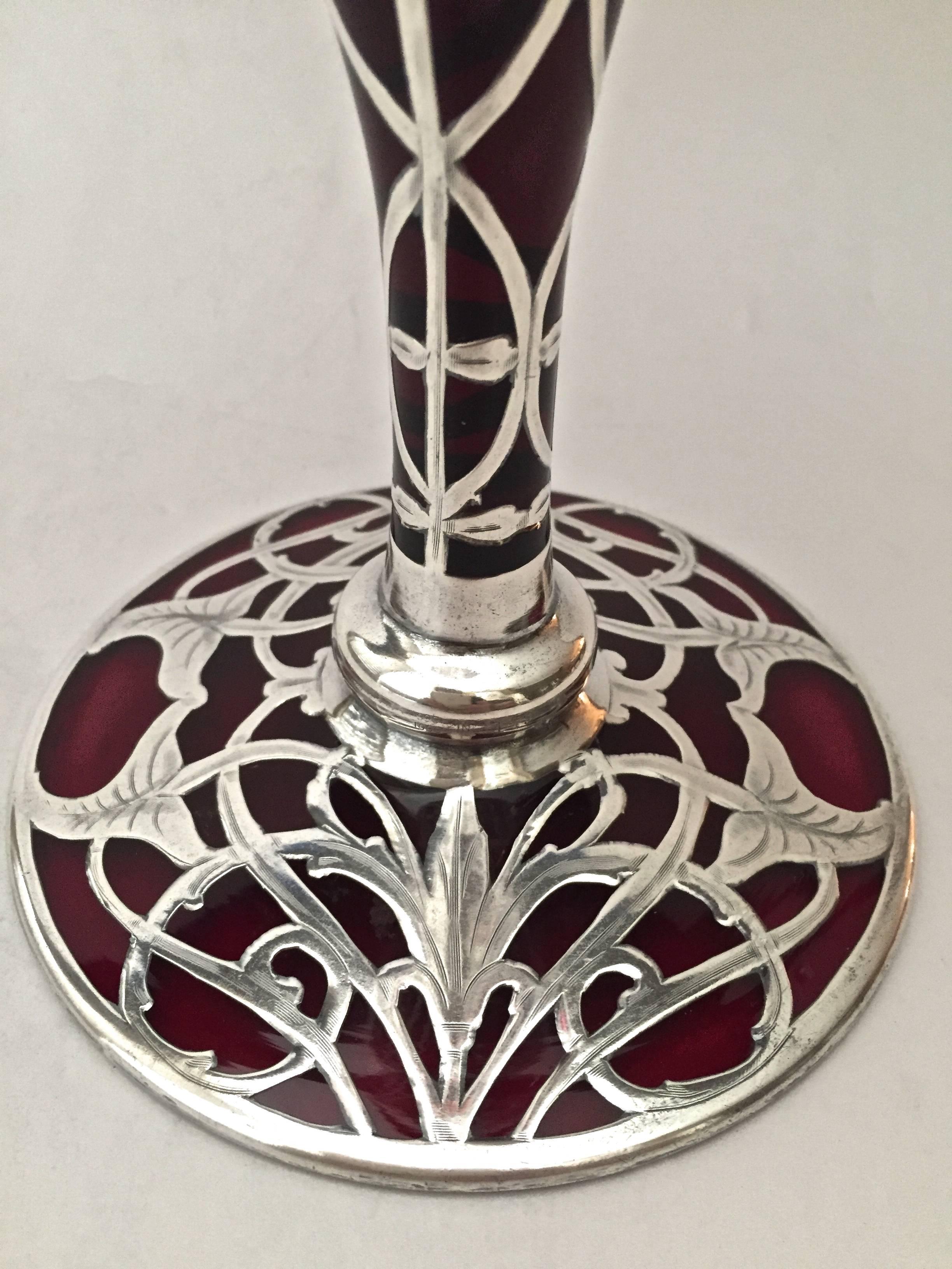 A very large Art Nouveau sterling silver overlay vase with ruby glass, circa 1900 the tapering cylindrical form having an overlay of sterling silver with flowers. Lovely chasing to the flowers and leaves, the style of Art Nouveau is present here.