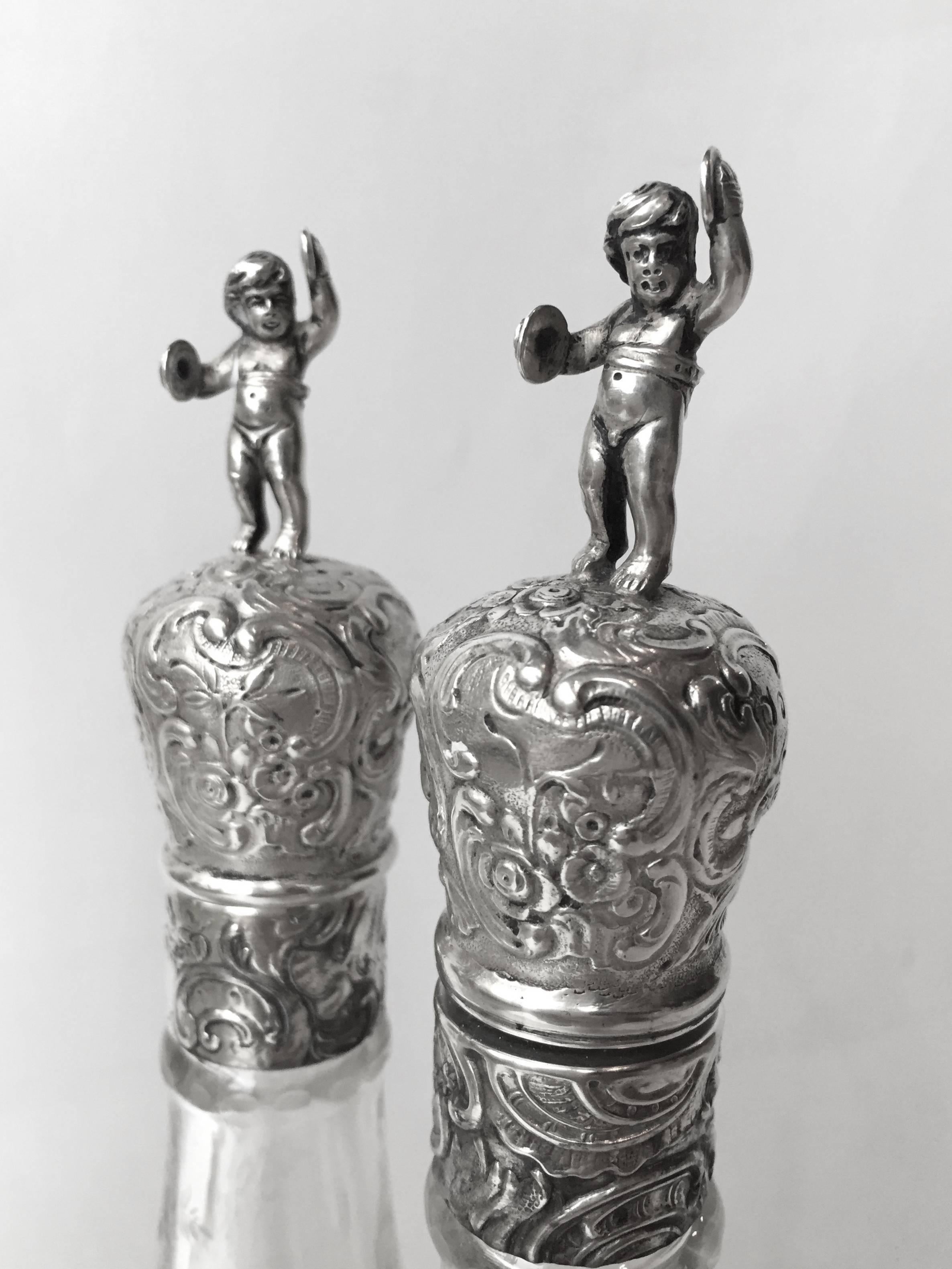 A fabulous double pair of German fine 800 silver decanters richly cast and chased with wonderful subject matter the pair made circa 1900 and are in excellent condition great on the table and in the bar.