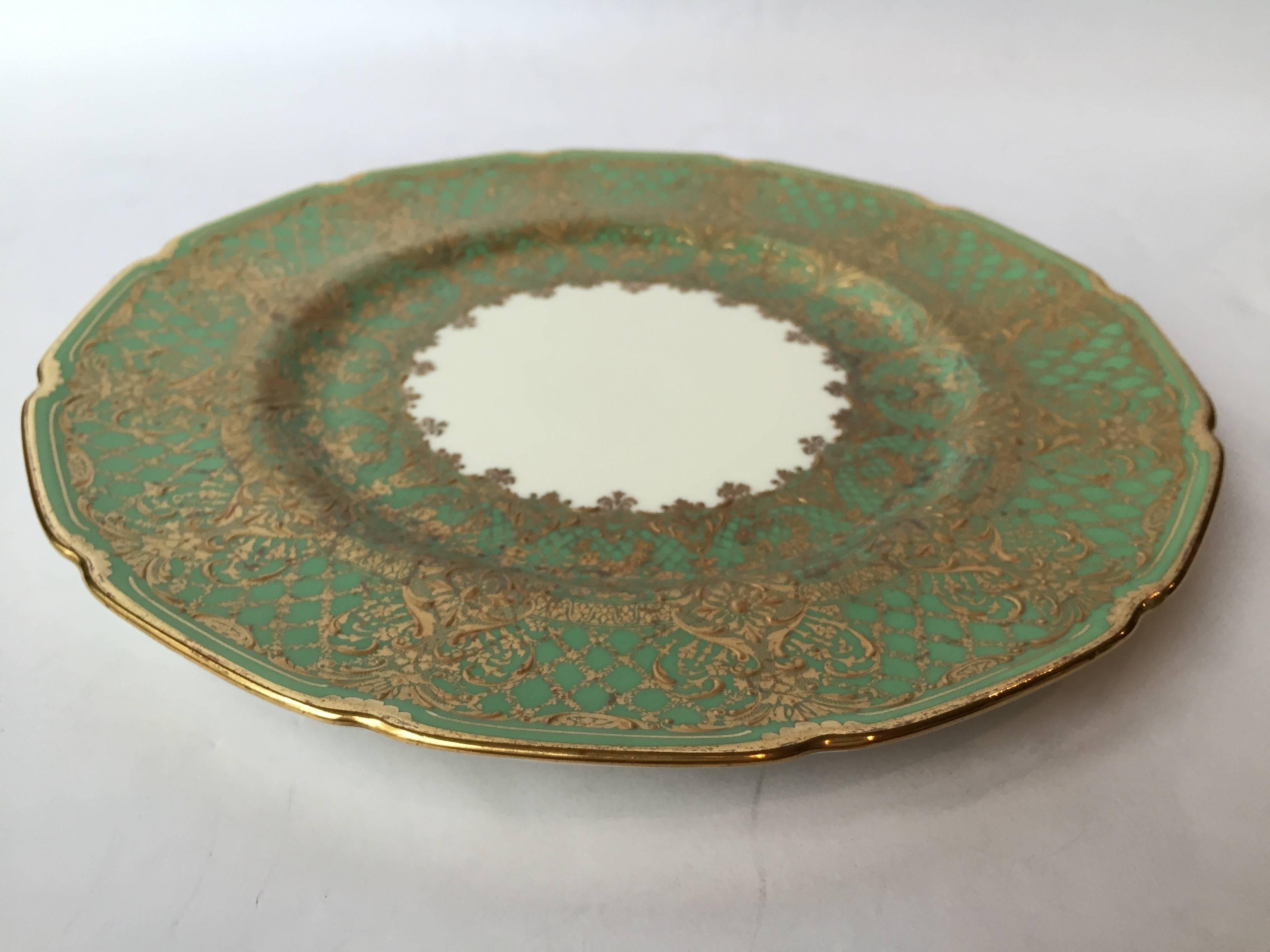 Absolutely gorgeous set of 12 service plates replete with raised paste gilt in a beautiful pattern on a very large boarder, perfect for the holidays and would
be great on display in your cabinet.