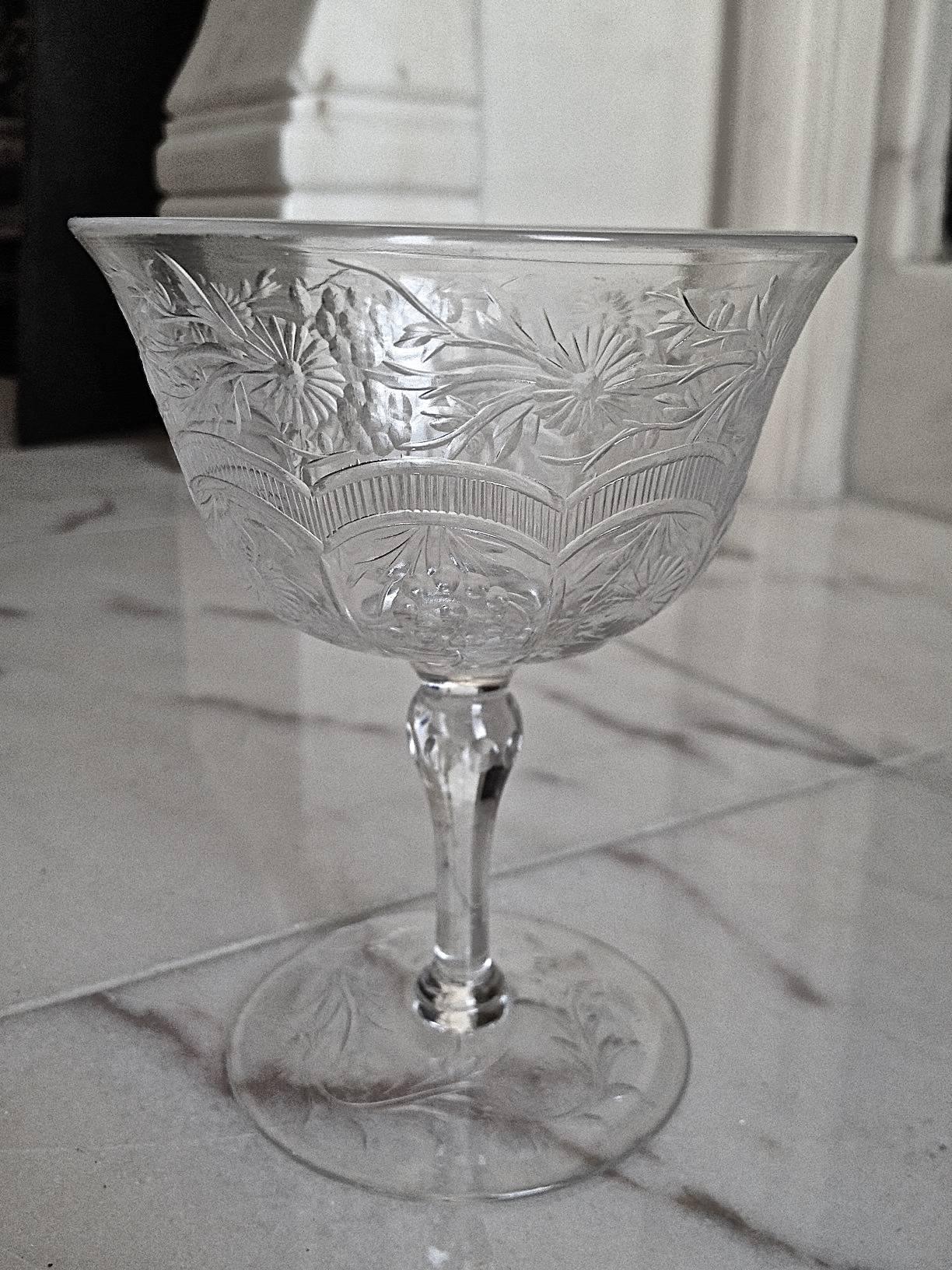 A fantastic set of exceptionally wheel cut-glass stemware, sorry it is most hard
to photograph clear glass, it is crystal clear and covered with flowers and vines
also with ribbing and raised panels to the bottom of the bowl causing a 3d