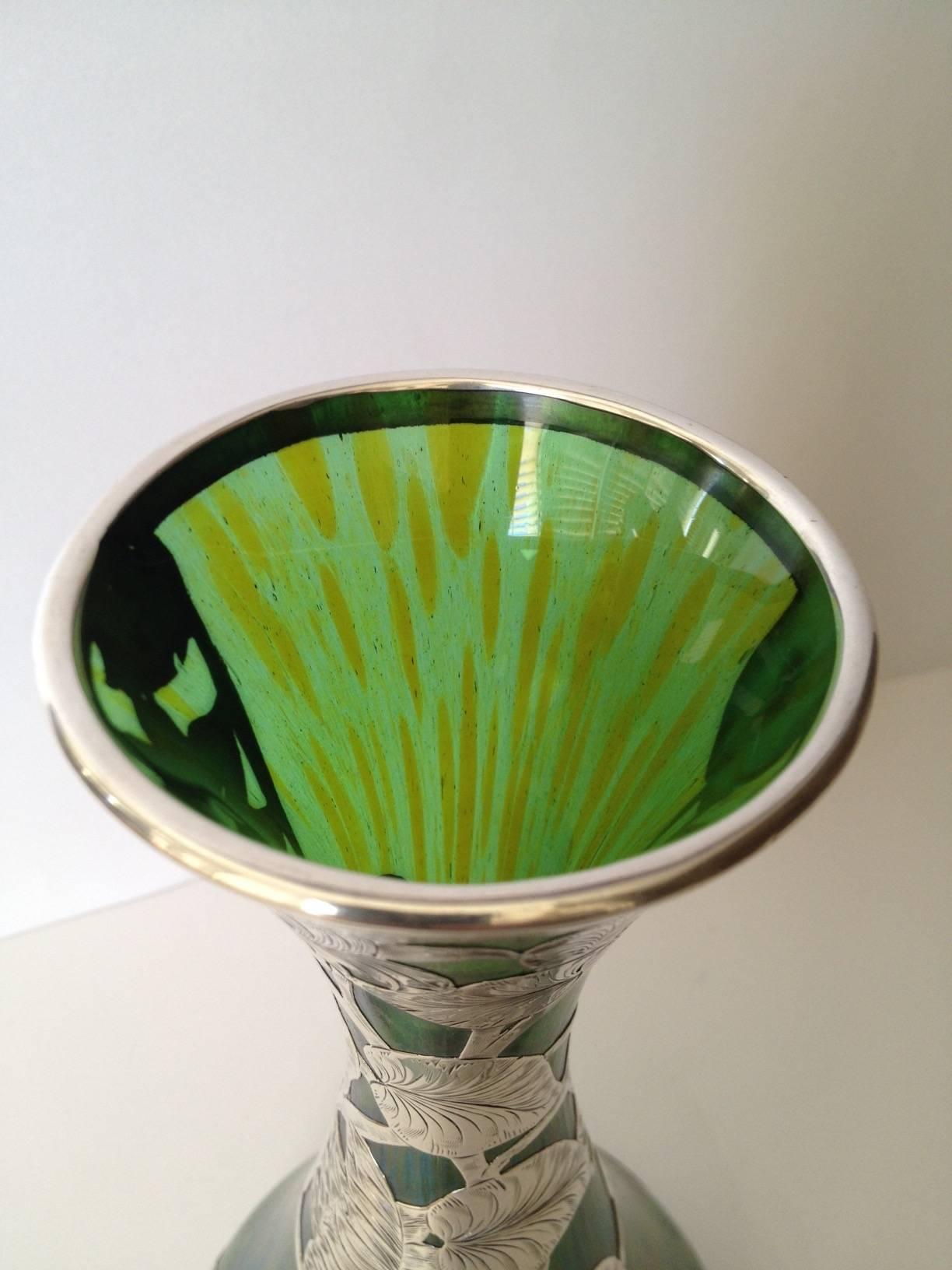 A large and awesomely beautiful Loetz art glass vase
with sterling silver overlay by Alvin Silver Co. The Art
Nouveau vase with the iridescent finish mastered at the Loetz Factory combined with the silver Work by Alvin which is chased expertly. In