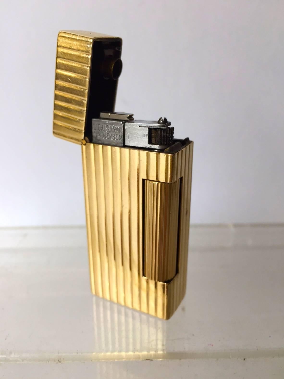 This lighter is in fantastic condition, lid functions as new, opens with the turn of the roller bar, lid pops open and the lighter ignites, very cool. The lighter has not been monogrammed a plus. The lighter is a vintage fluid model. The flint
