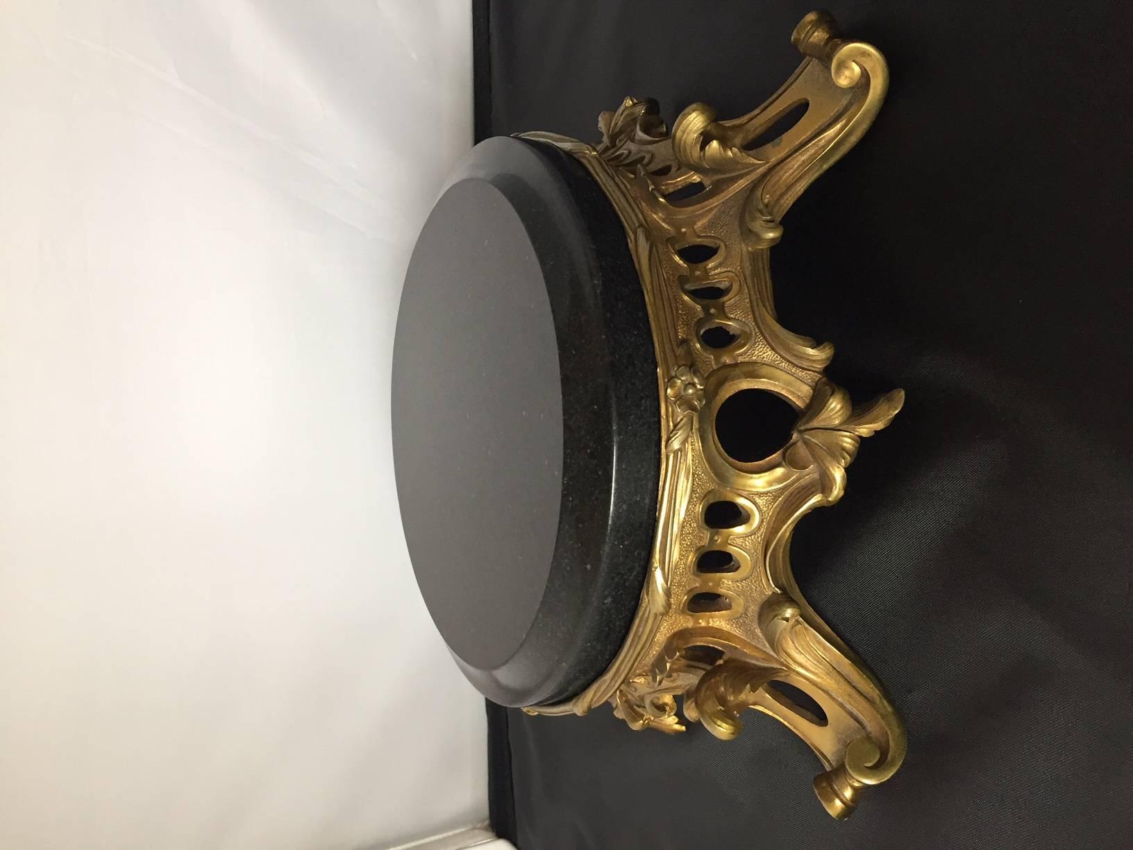 A very fine French Ormolu centerpiece crisply cast and chased retaining its original gold in fantastic condition with a black marble top.