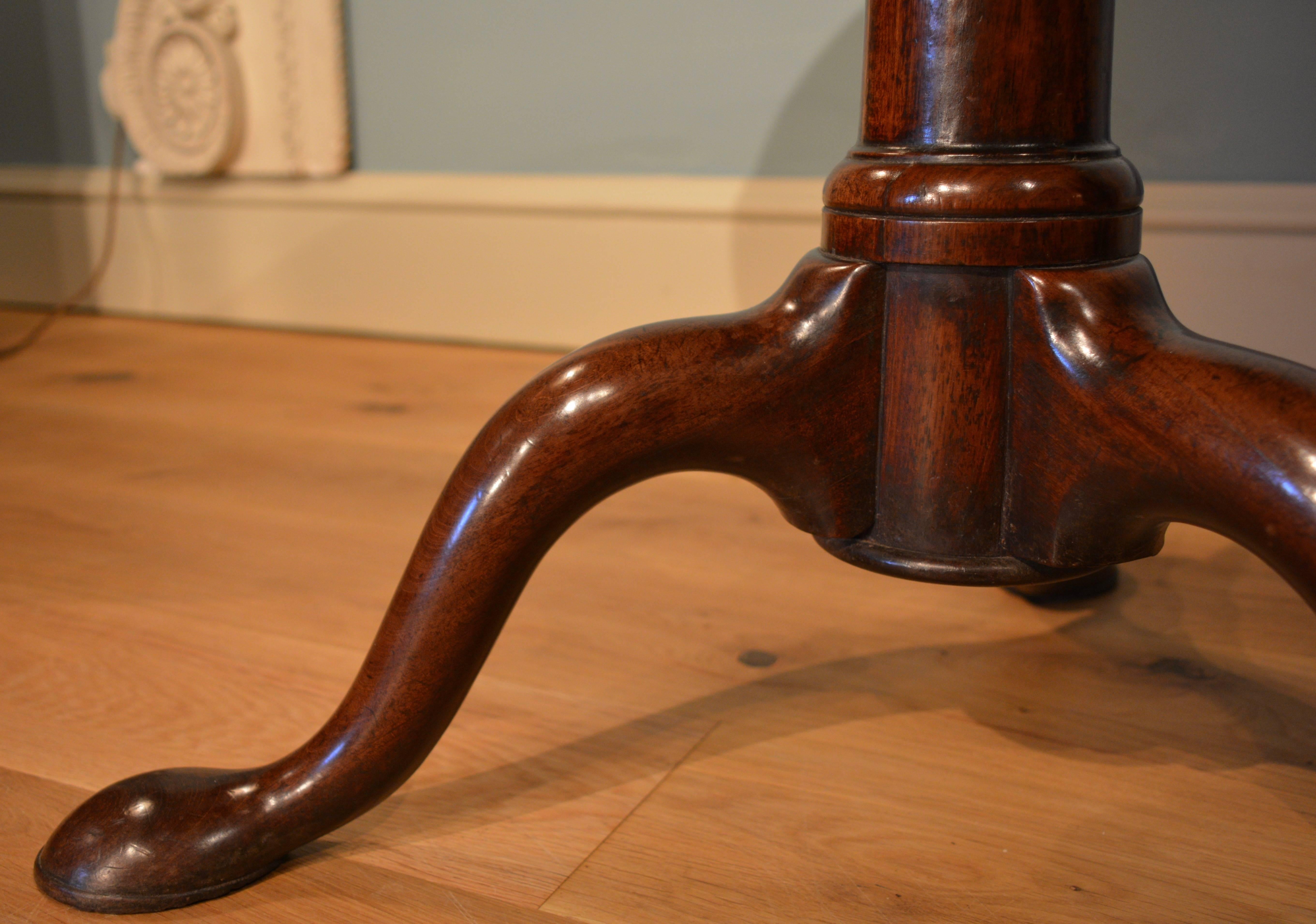 A George II mahogany dish top tripod table having birdcage action of excellent color and patination.
 
