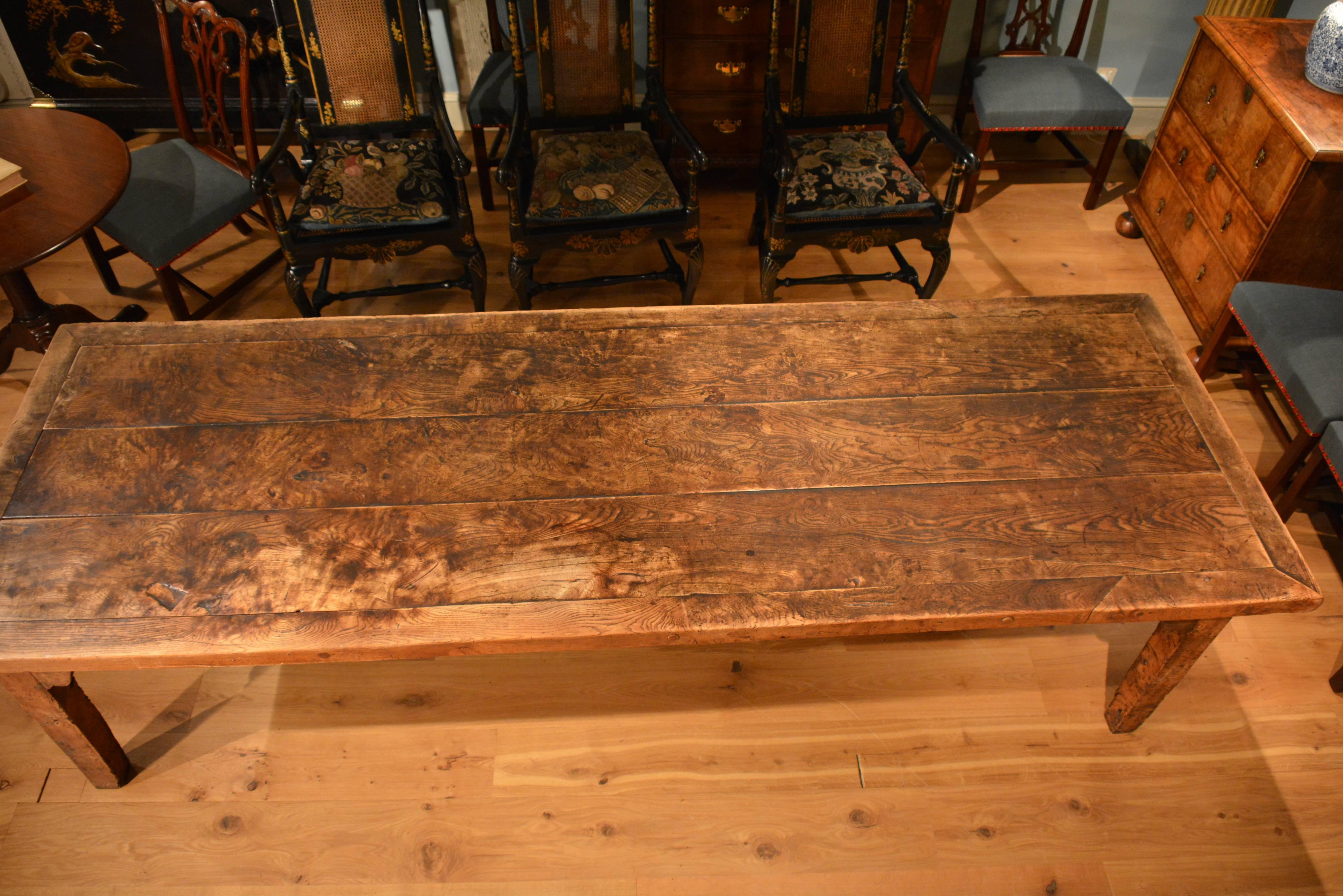 A large George III ash farmhouse table of exceptional colour and surface. The planked cleated top standing on its base with heavy square tapered legs, circa 1800.