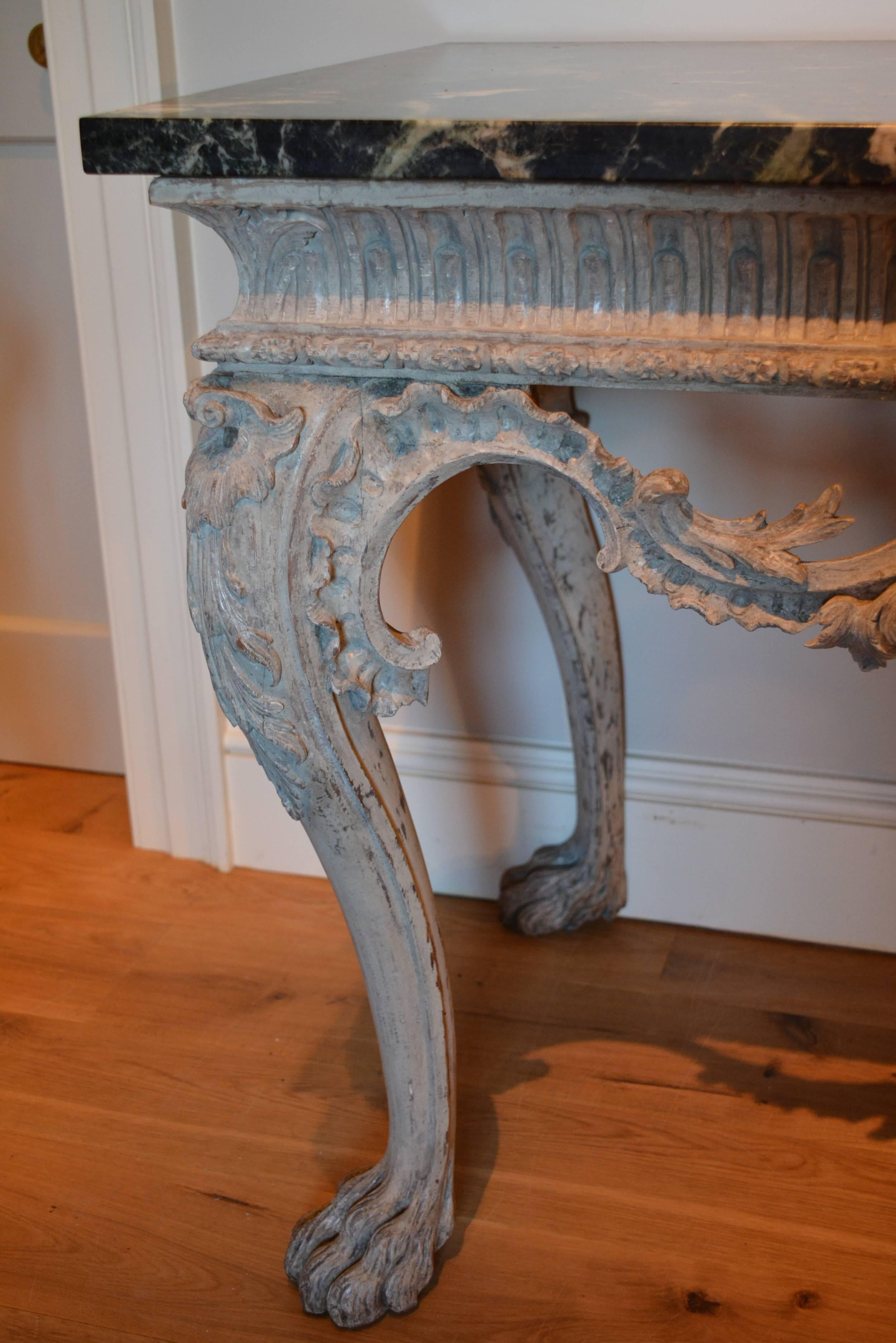 An 18th century finely carved painted pine marble top side table.