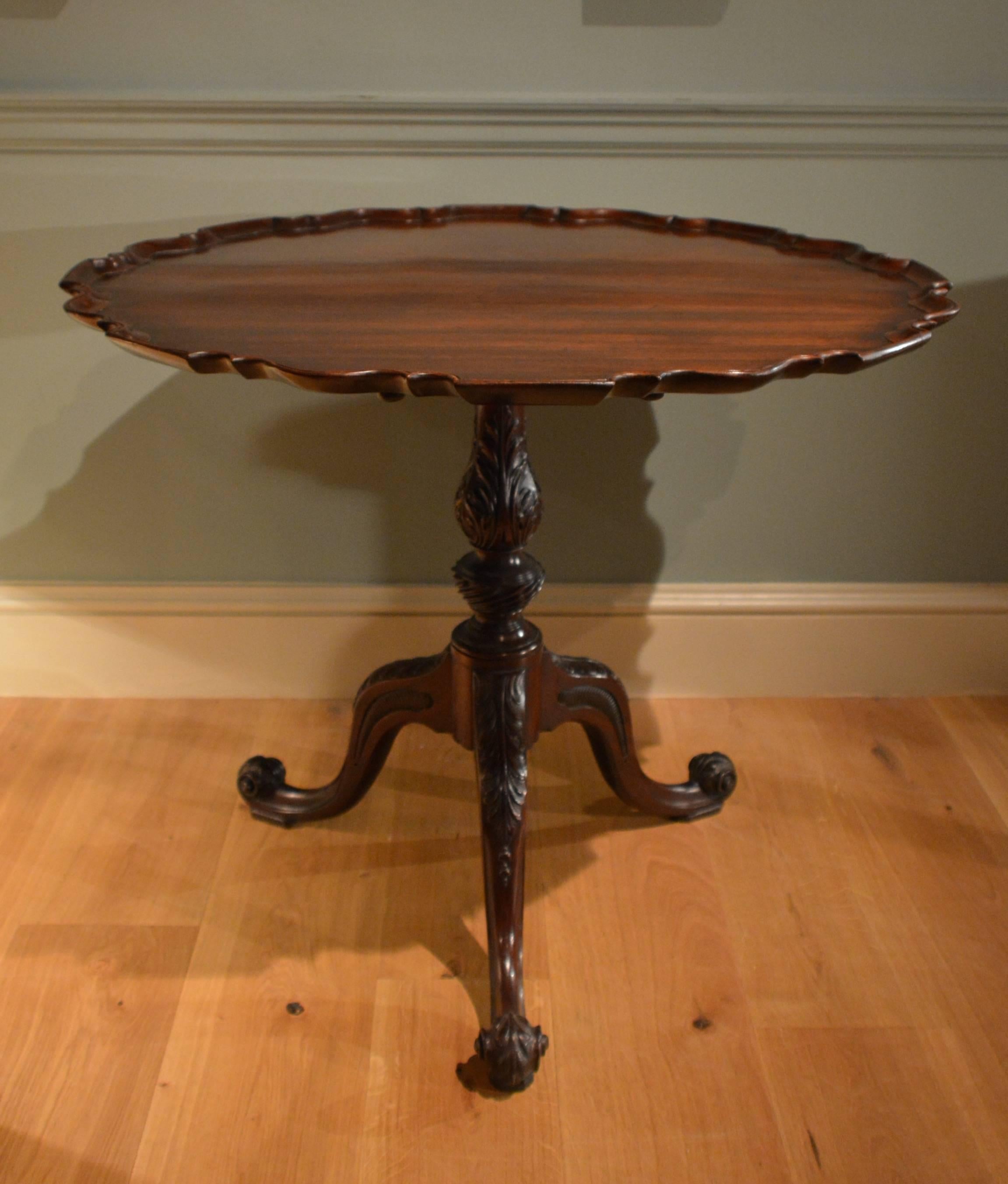 A fine George III mahogany tripod table, the stem and knees enriched with acanthus carving, the legs ending in boldly scrolled toes.
English Circa 1760