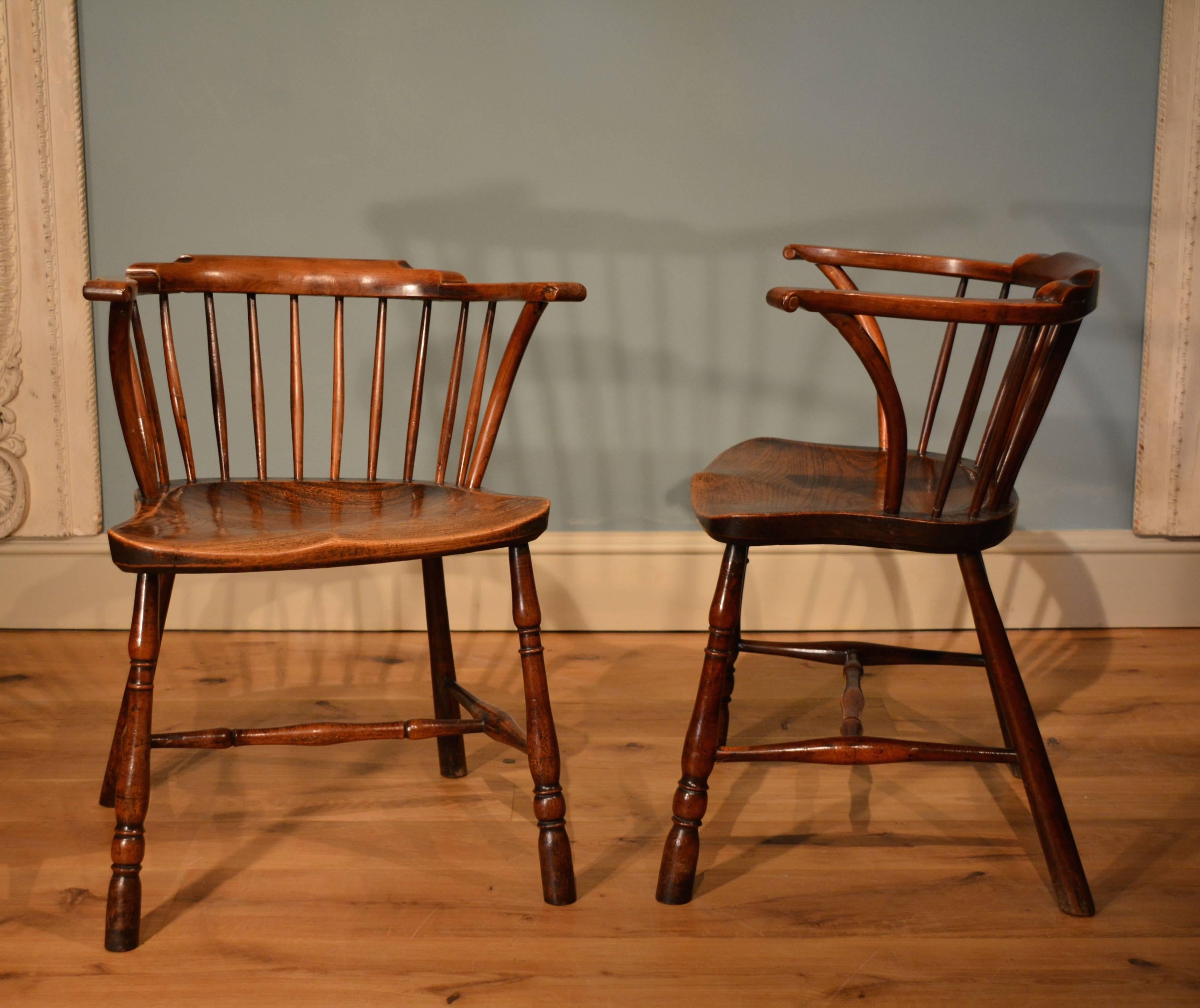 A rare pair of low back yew wood 'library chairs' having elm seats standing on turned legs with turned stretchers.