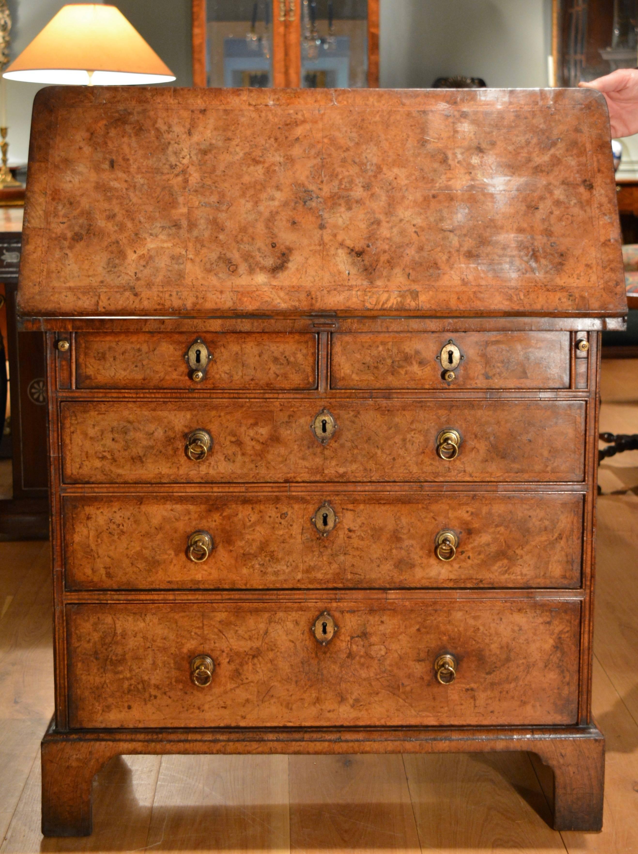 A fine George I bachelors chest veneered in burr walnut, in good original condition with excellent colour and patination. The folding top above two short and three long drawers, the whole standing on bracket feet, English, circa 1725.