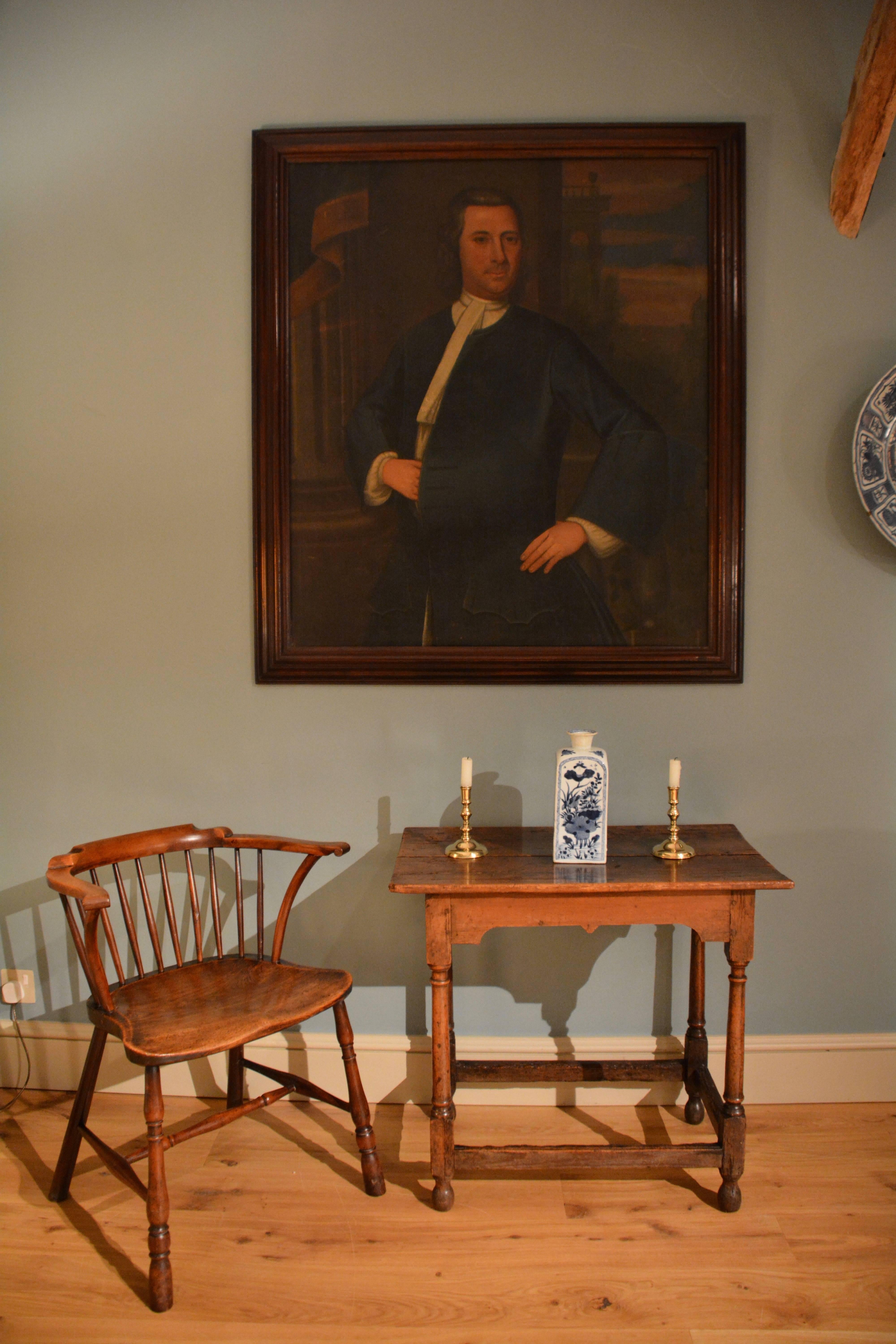 An early 18th century provincial oil portrait of a gentleman depicted against a classical background in it's original bolection moulded oak frame, English, circa 1730.