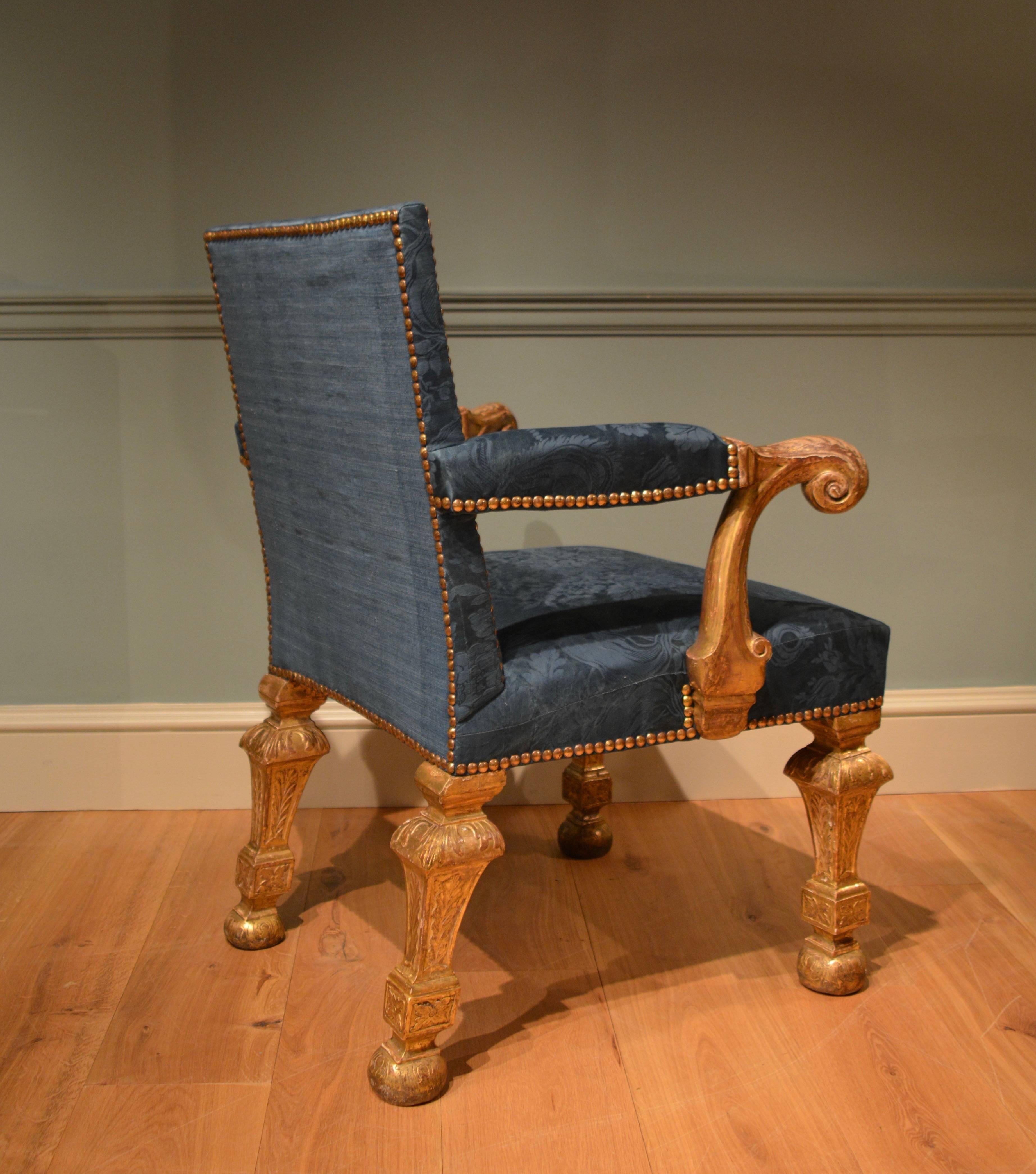 A fine and rare early 18th century gilt armchair with upholstered seat and back, the padded out scrolling gilt arms above four square inverted pillar legs decorated with fine cut gesso work. This chair retains it's original gilt surface and is