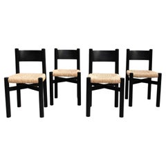 Ensemble de quatre chaises en bois et rotin d'après Charlotte Perriand, datant d'environ 1980