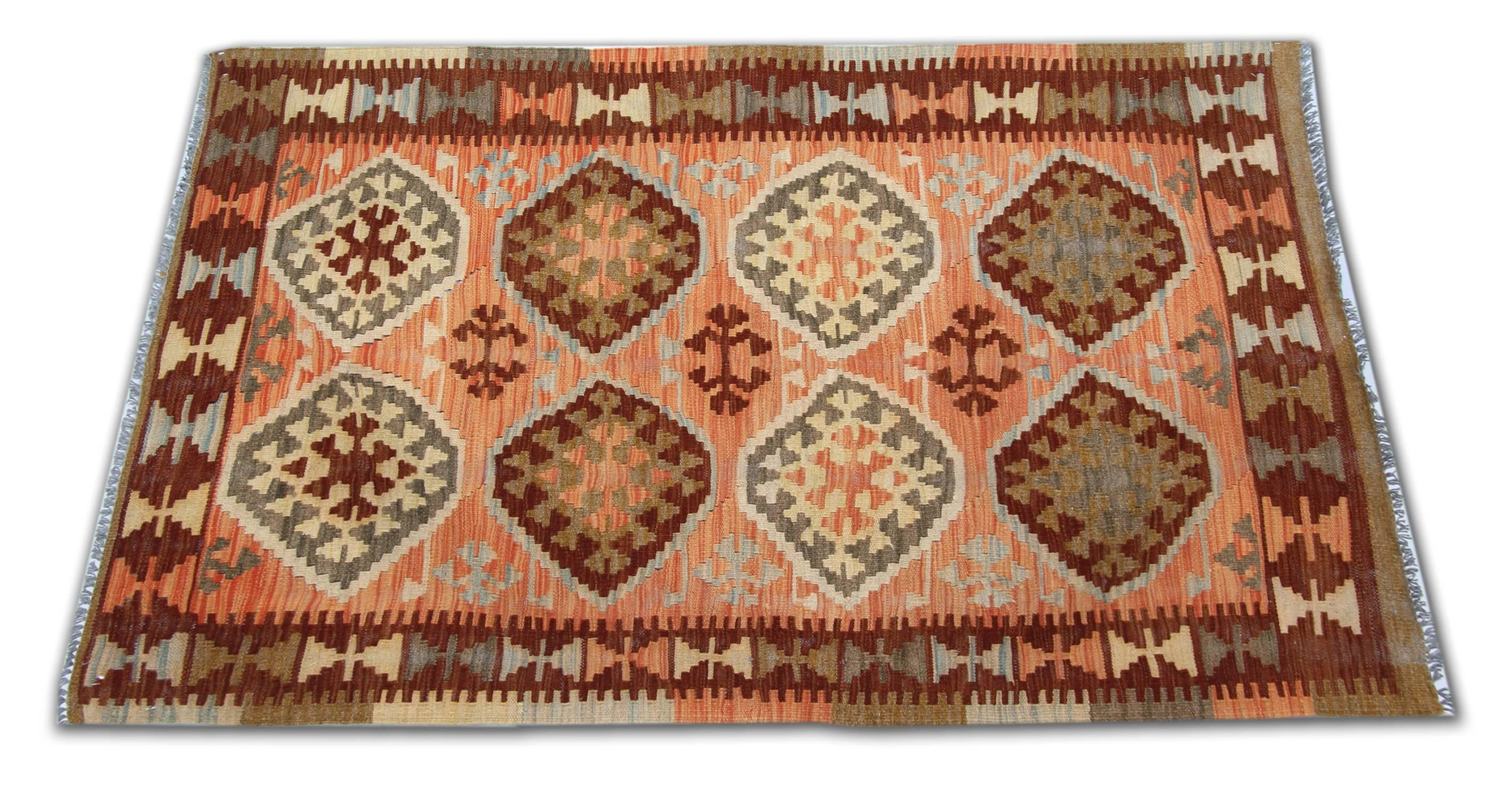 This Kilim rug is contemporary because is newly handmade in Afghanistan by Uzbek and Turkman tribes but shows traditional symbols deriving from the Persian Qashqai tribes. The materials used are wool and cotton of the highest quality in addition the