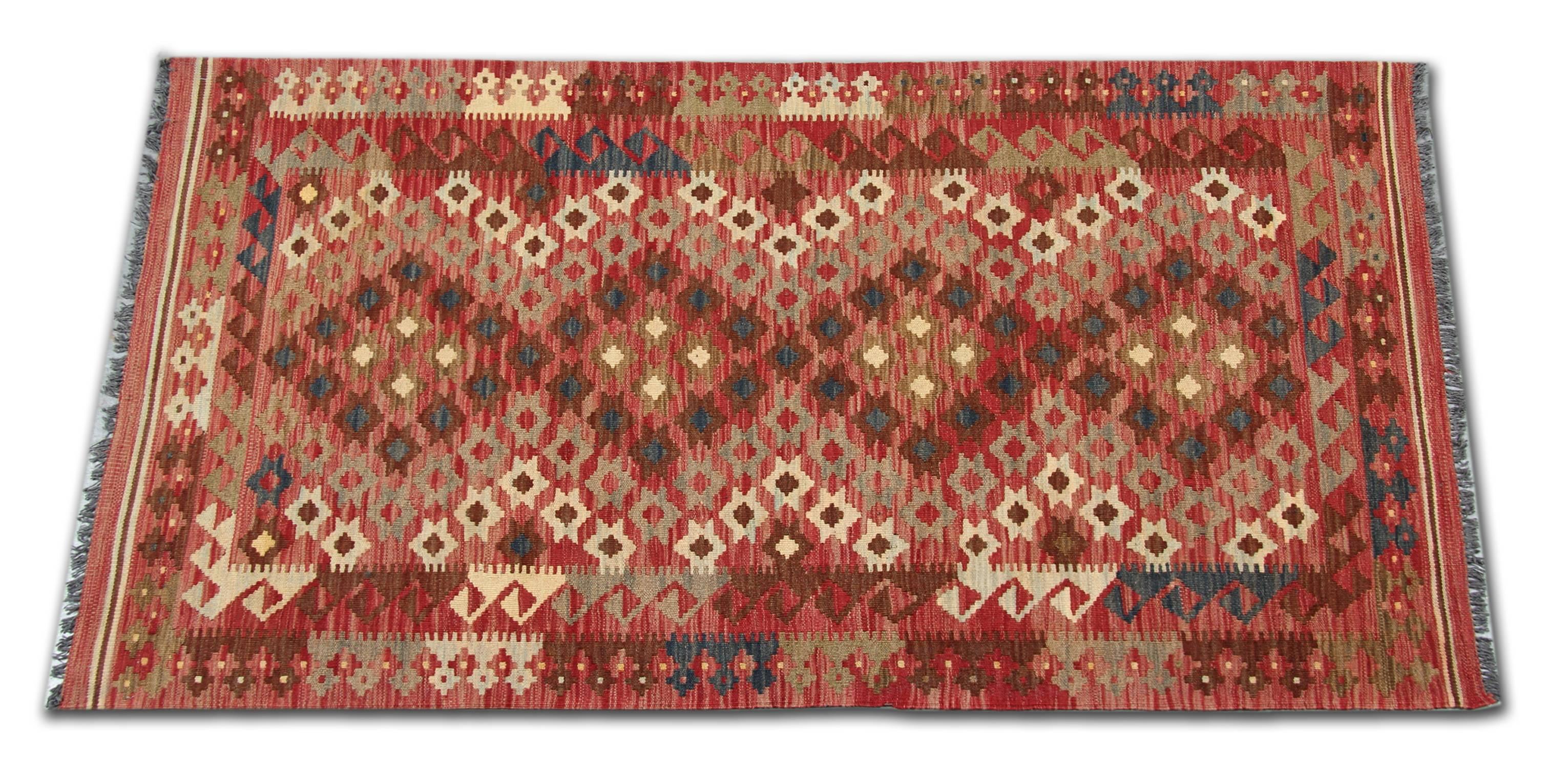 This Kilim rug is handmade in Afghanistan by Uzbek and Turkman tribes. The main materials are wool and cotton, locally sourced. The dyes are organic. The quality of the materials enhances the value of the carpet and its hard wearing features. The
