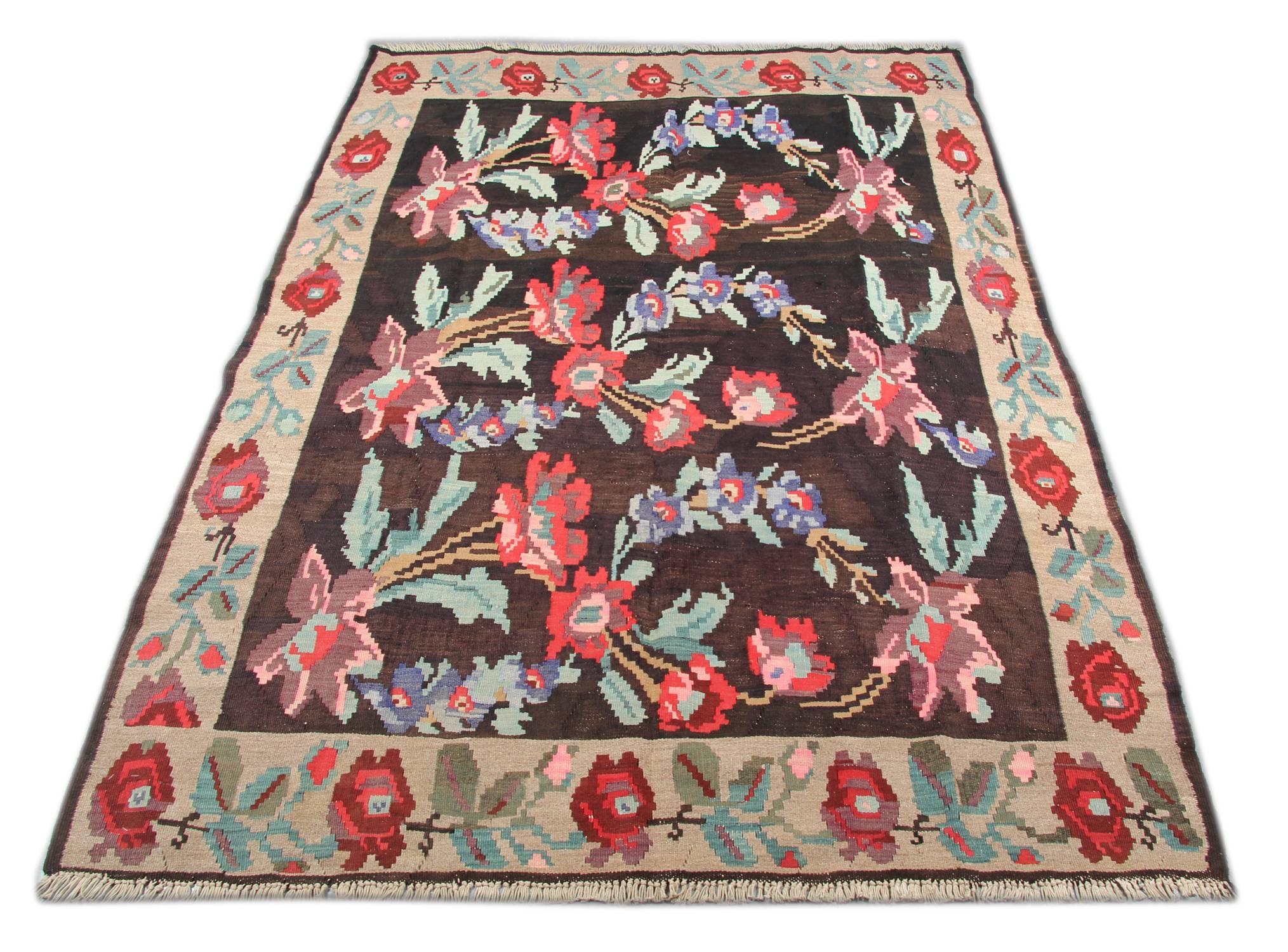 This oriental rug vintage Moldovian floral rug is from Romania, handwoven in, circa the 1920s which have used unusual color combinations. Torn between the influences of the Ottoman Empire to the south and Russian and Slavic countries to the north,