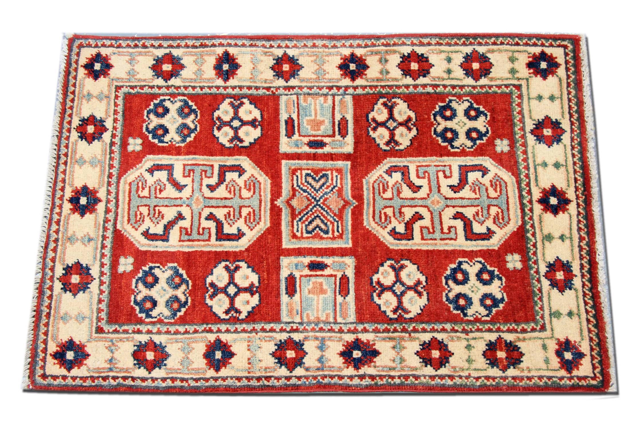 This Kazak red rug has a traditional border with two medallions. The central area of this tribal rug symbolises a garden of paradise protected by the 'walls' of geometric rug patterns. Traditional rugs would complement your home as floor rugs. These