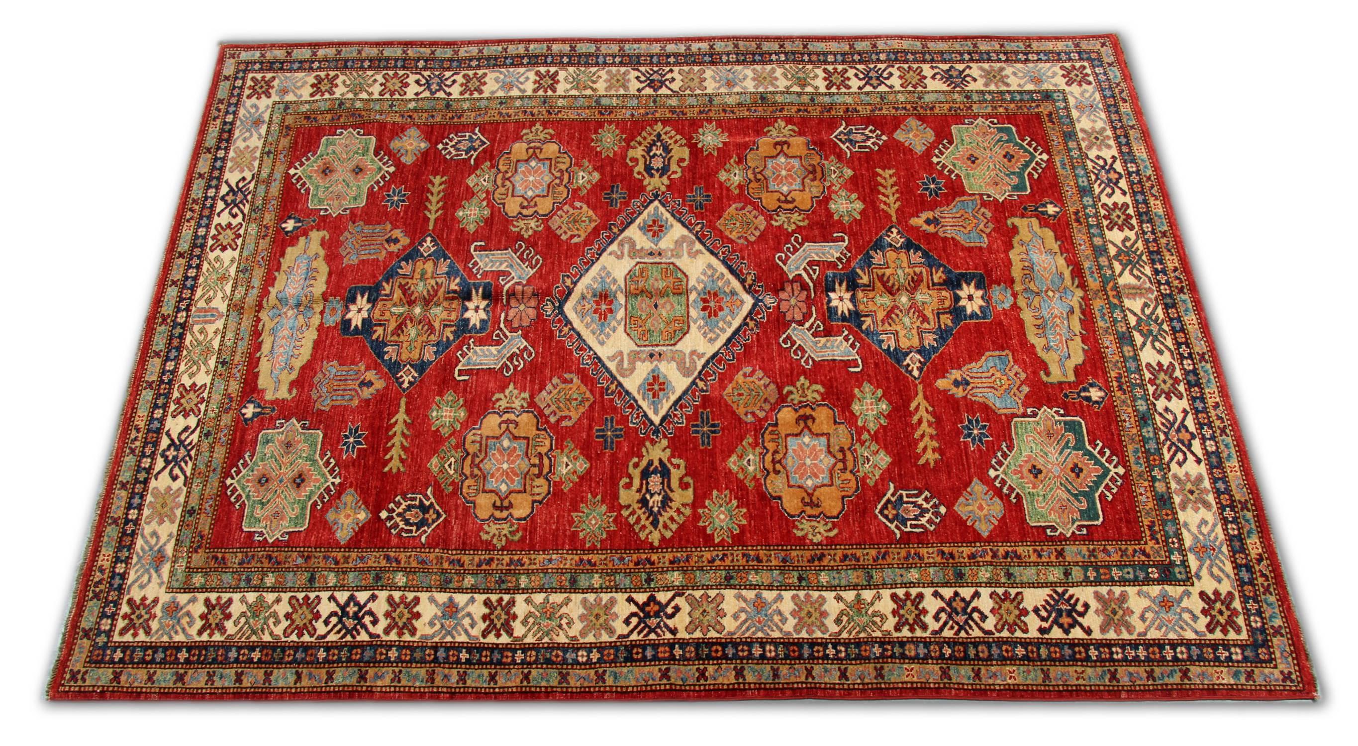 These new traditional handwoven rugs are featuring tribal rug designs from the Kazak region. This red rug has been made by Afghan weavers of top quality wool and cotton. These patterned rugs feature a typical geometric rug pattern. Dominant colours