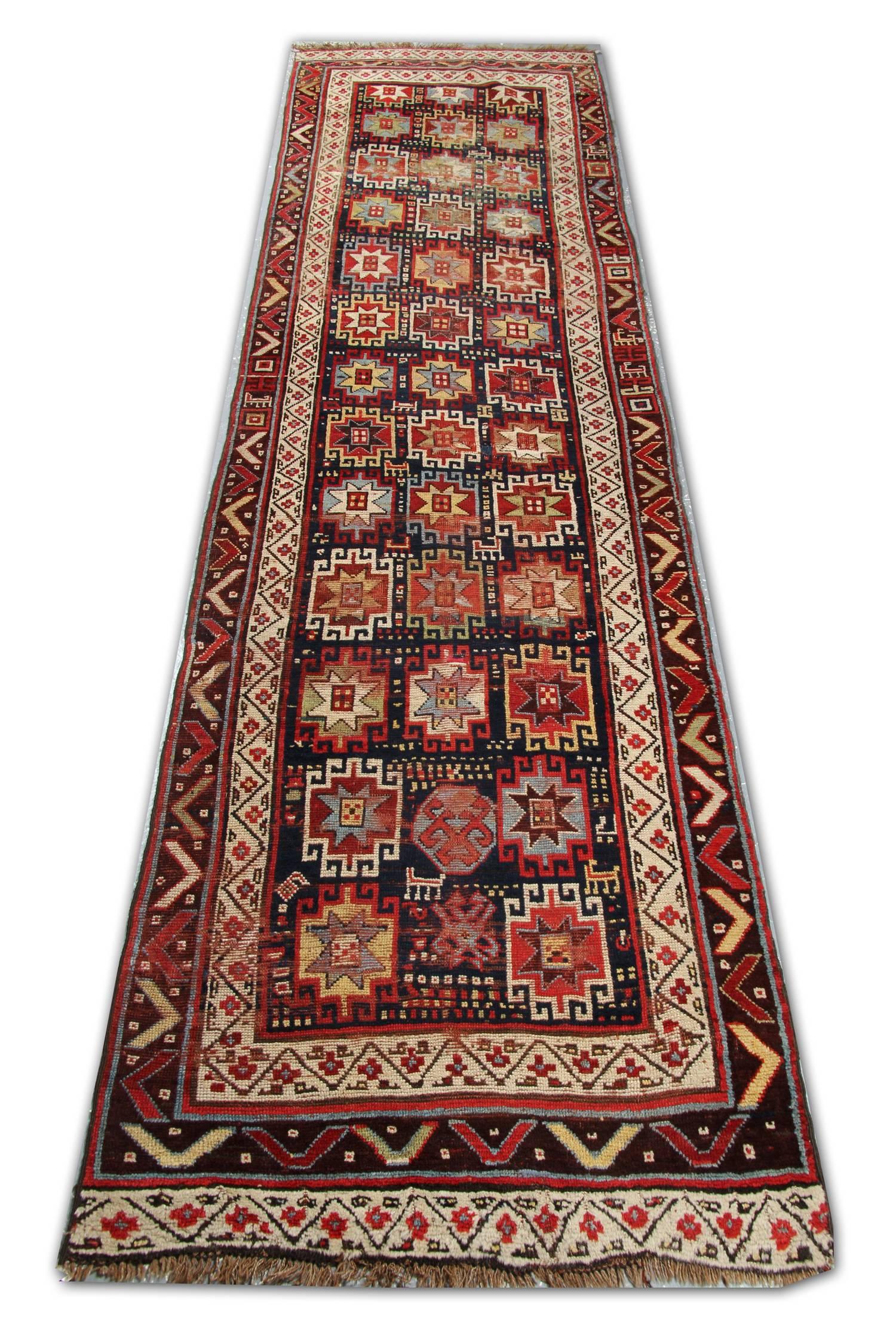 A fantastic, cheerful old tribal rug by the Kurds who inhabit the mountains on the North West of Iran. Authentic weaving traditions of wool rugs continued far longer in this remote region than in other parts of Iran. These runner rugs have excellent
