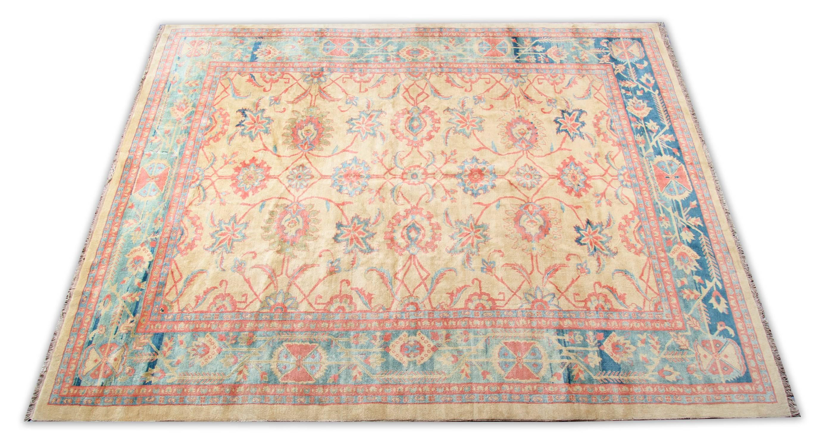 A 20th-century handmade carpet Ziegler Mahal woven rug. The gorgeous floral rug field is woven with indigo, crimson, gold and coral vegetable-dyed wool, on a shiny gold dyed, wool background. The carpet rug border is fantastic with a full central