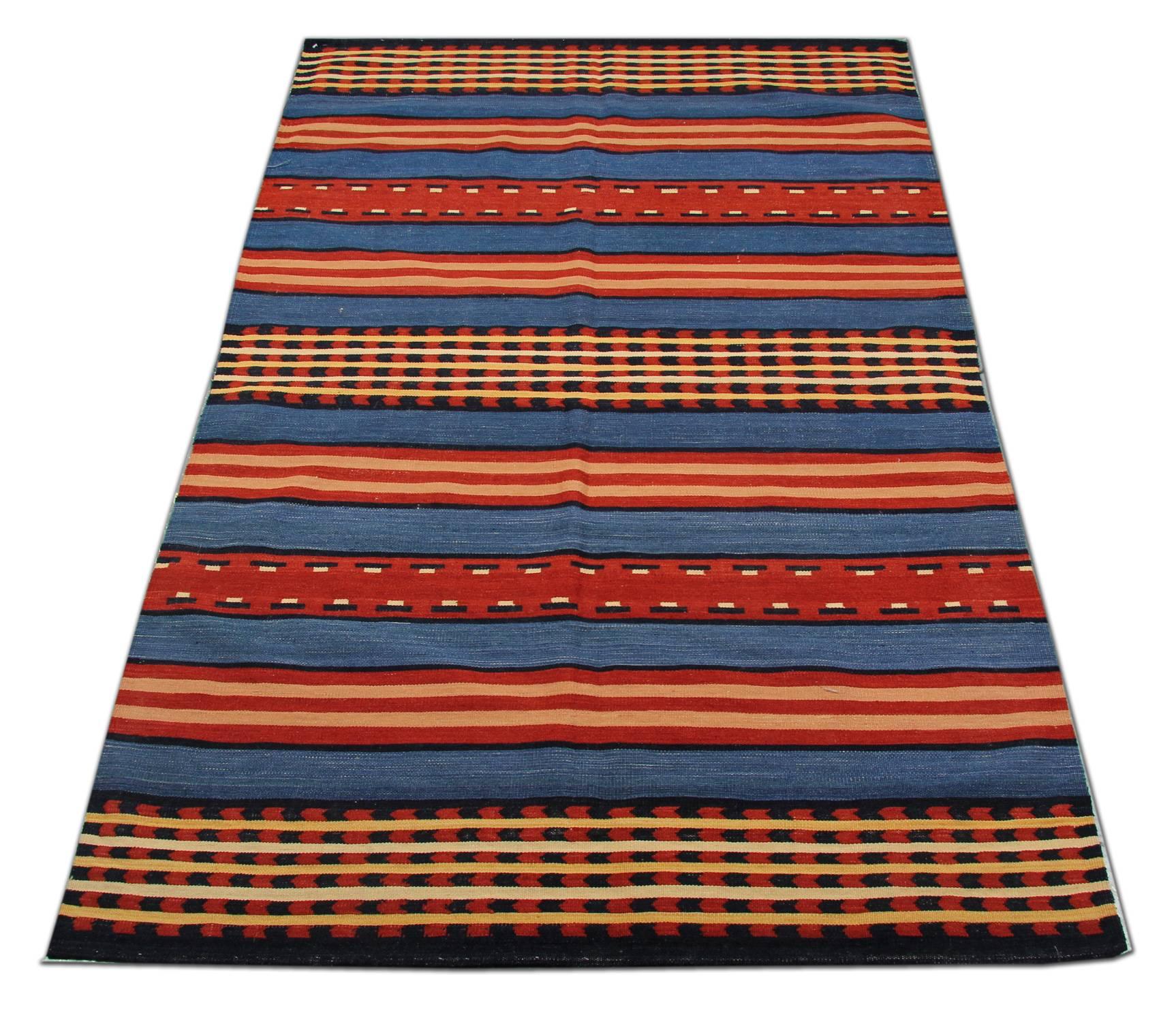 This fantastic wool rug is a handwoven Kilim constructed in Afghanistan, 1999. It features a simple yet eye-catching stripe design with colors of white, blue and beige. The simple stripe design has been woven with geometric pattern through our