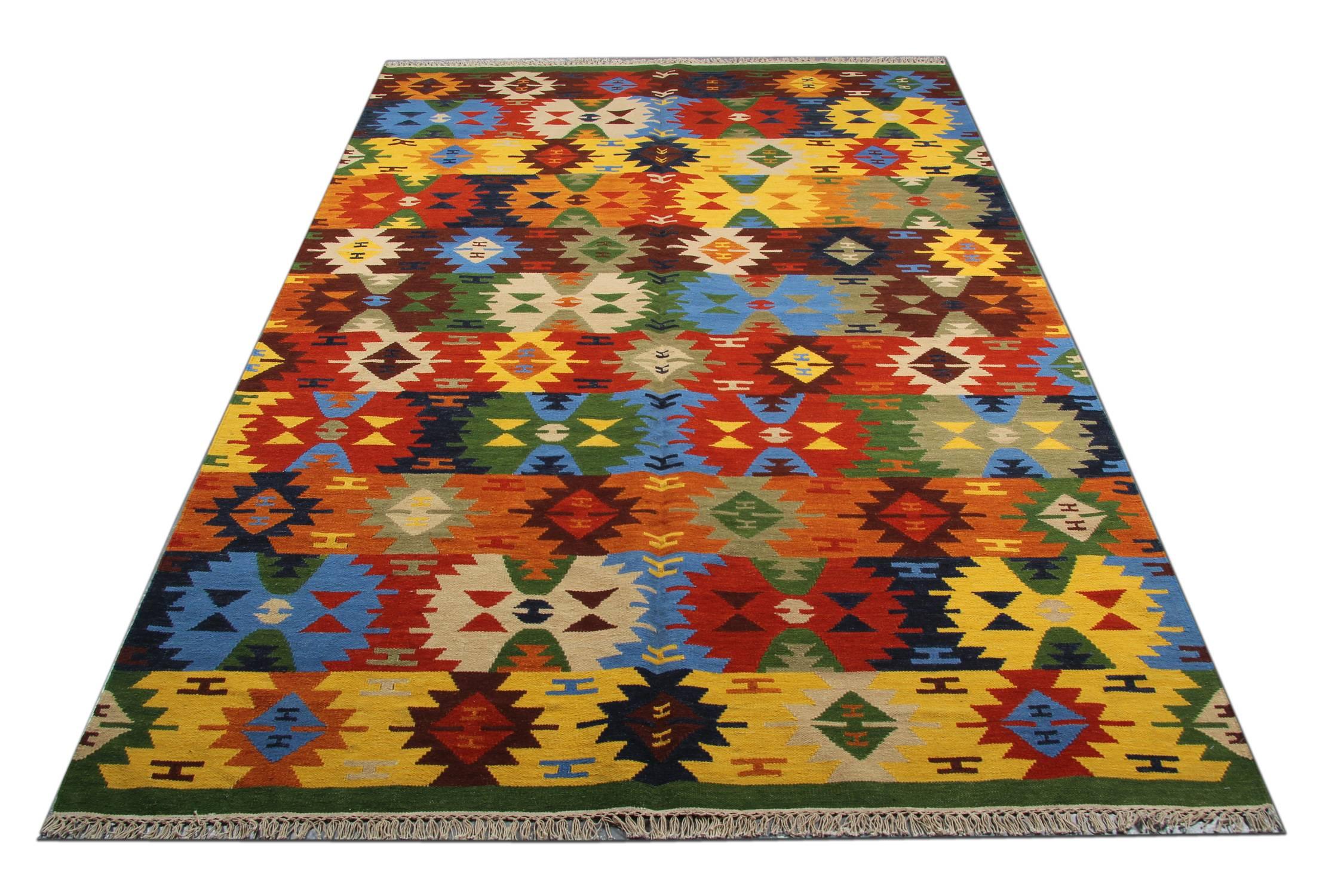 This beautiful wool area rug has been woven by hand and features a fantastic stripe geometric design. Woven in accents of brown, blue, green, yellow and rust. Symmetrically woven with sophistication this piece is sure to uplift any room it is