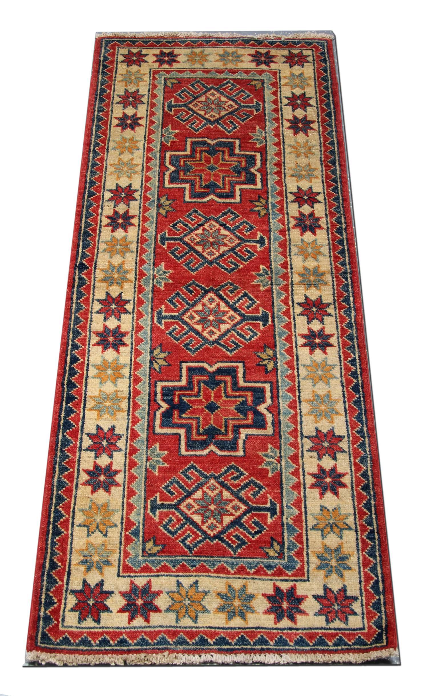 This new traditional hand-woven rug comes in a striking color combination of bright red, navy, light blue, sea blue, cream, and caramel. These patterned rugs are influenced by the Caucasian designs of Northern Persia. This red rug has a cream yellow