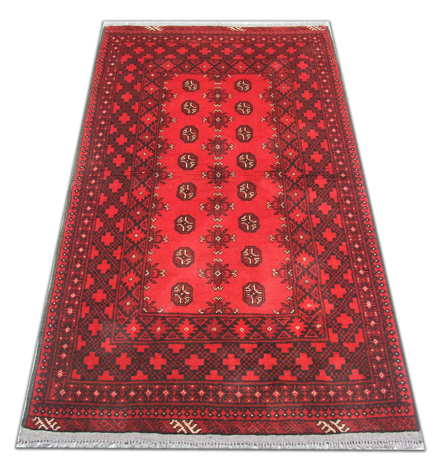 This is an example of fine Afghan red rug made by highly skilled Turkman handmade rugs weavers in the north of Afghanistan. They have used hand spun wool and 100% organic dyes for the production of these wool rugs. This tribal rug has repeating