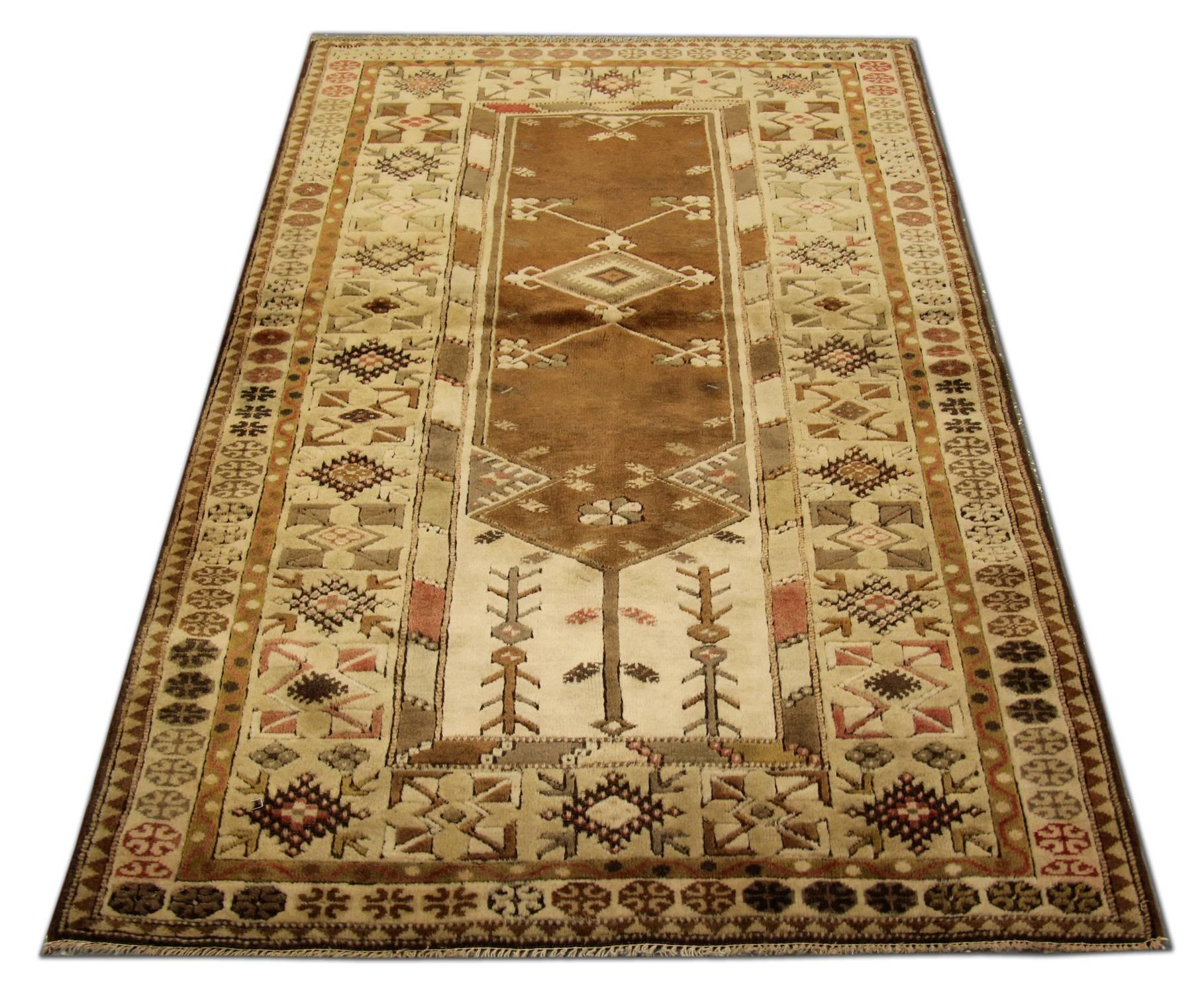 This soft color vintage Milas woven rug rests beautifully upon a field of pale lime green, light gray and brown colors. This geometric rug has a medallion of multi colors and neutrals takes center stage and the tribal rug is well balanced by four