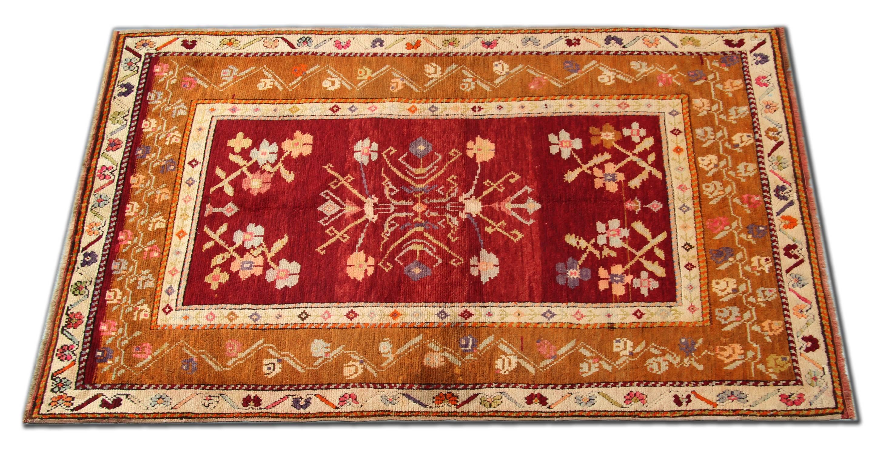 This red rug is a kind of beautiful hand knotted Turkish carpets or Anatolian rugs with geometric rug pattern and very elegant tribal and floral rug design. These wool rugs have vibrant natural dyes. The combination of rust red, orange, and gold in