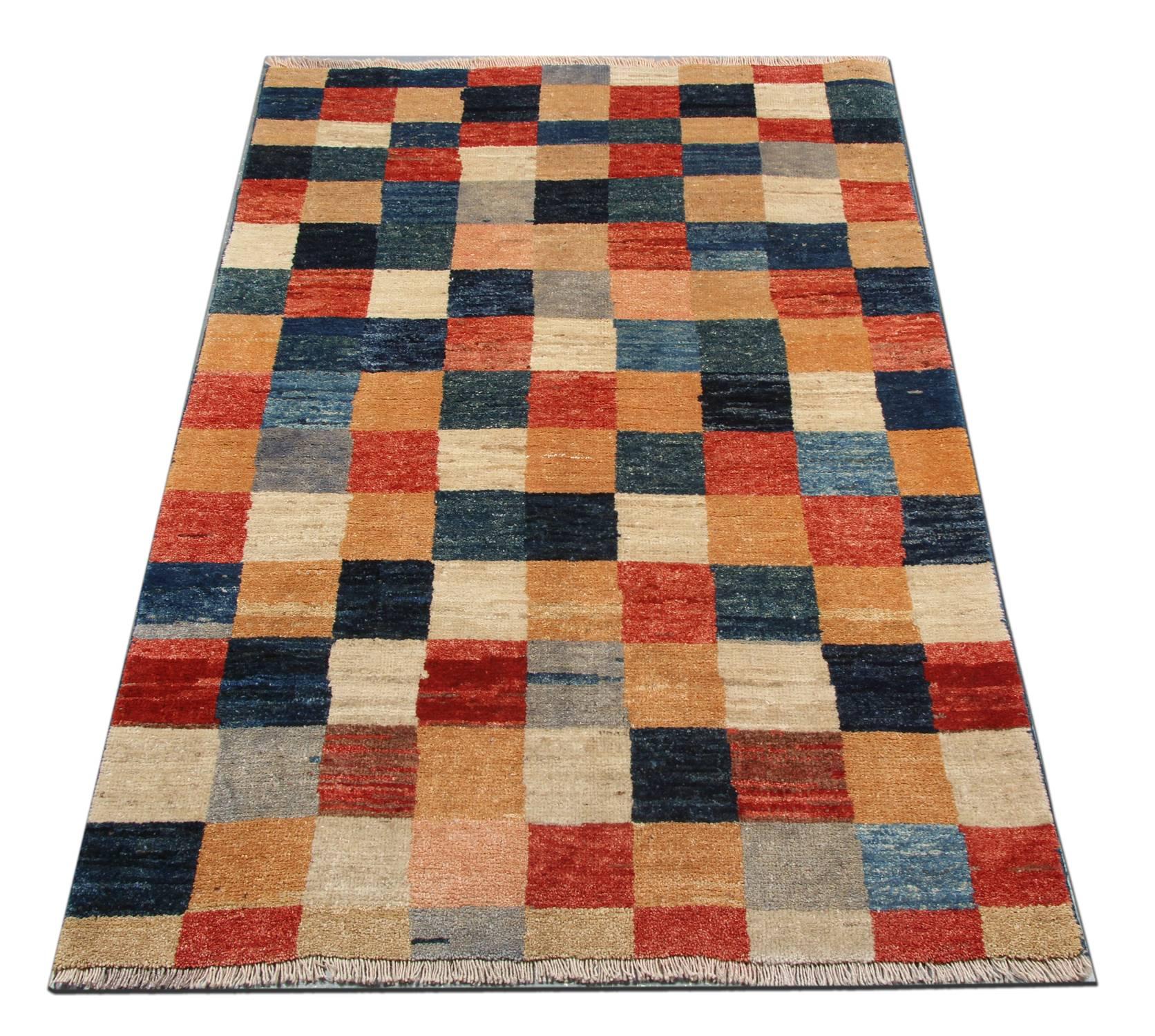 Handmade carpet wool rugs have rich colours and abstract elements and these modern rugs give a subtle contemporary appearance. This geometric Oriental rug is featuring a beautiful plaid palette of blue, gold, navy, rust, ivory and grey rug colours.