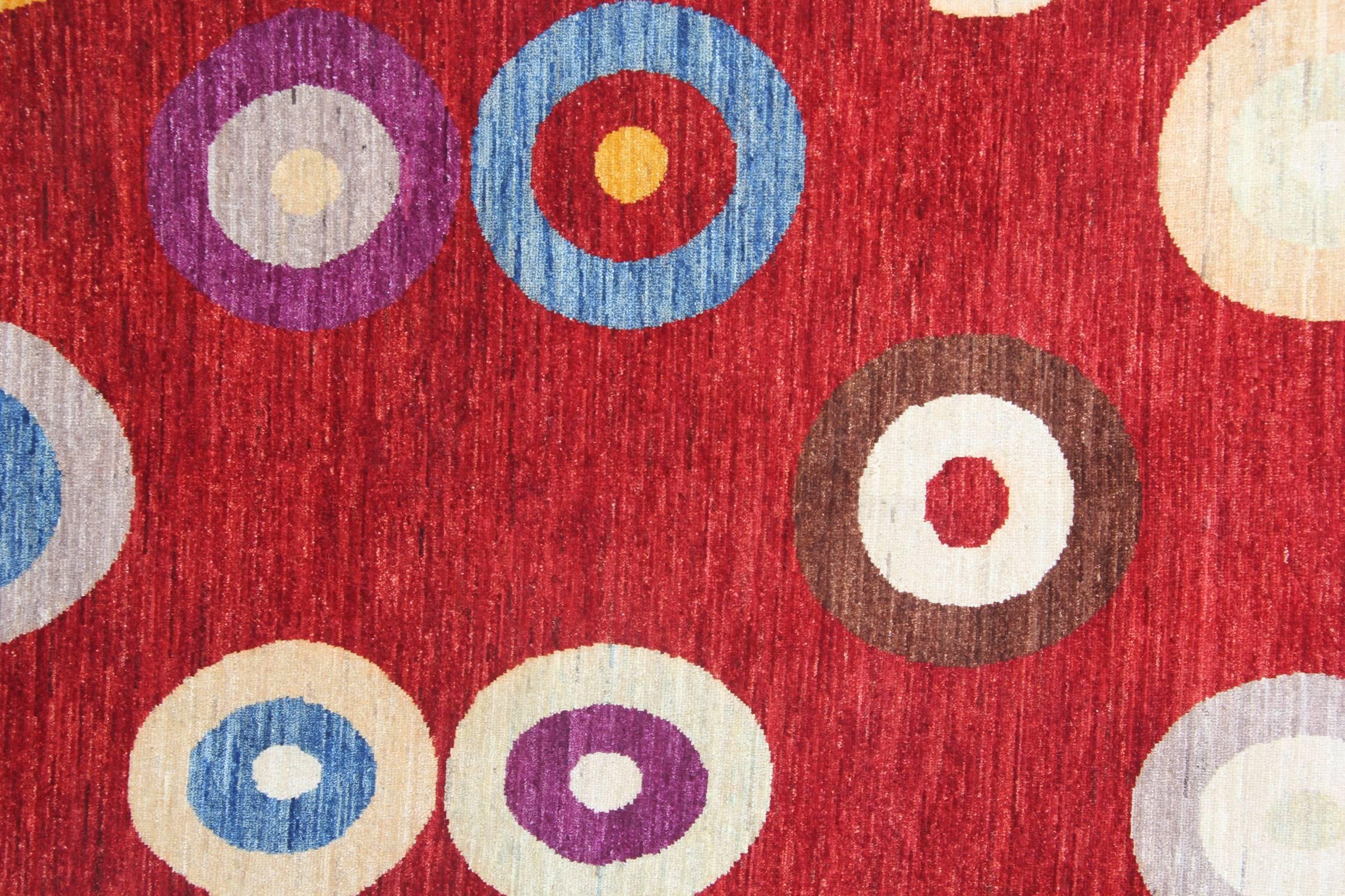 With rich colors and abstract elements, these handmade rugs give a subtle contemporary appearance. The red rug has a beautiful palette of blue, brown, ivory, gold and grey rug colors. These luxury rugs are grounded in stylish colors, which