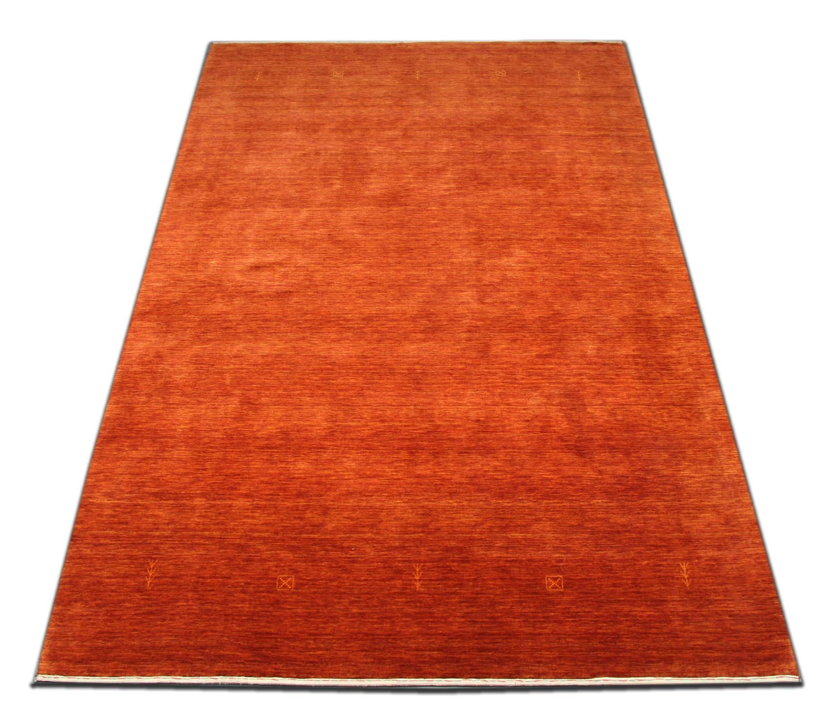With rich colors and abstract elements, this modern woven rug gives a subtle contemporary appearance. Featuring beautiful orange-red colors, this red rug is grounded in stylish colors that will add a touch of modernized sophistication to nearly any