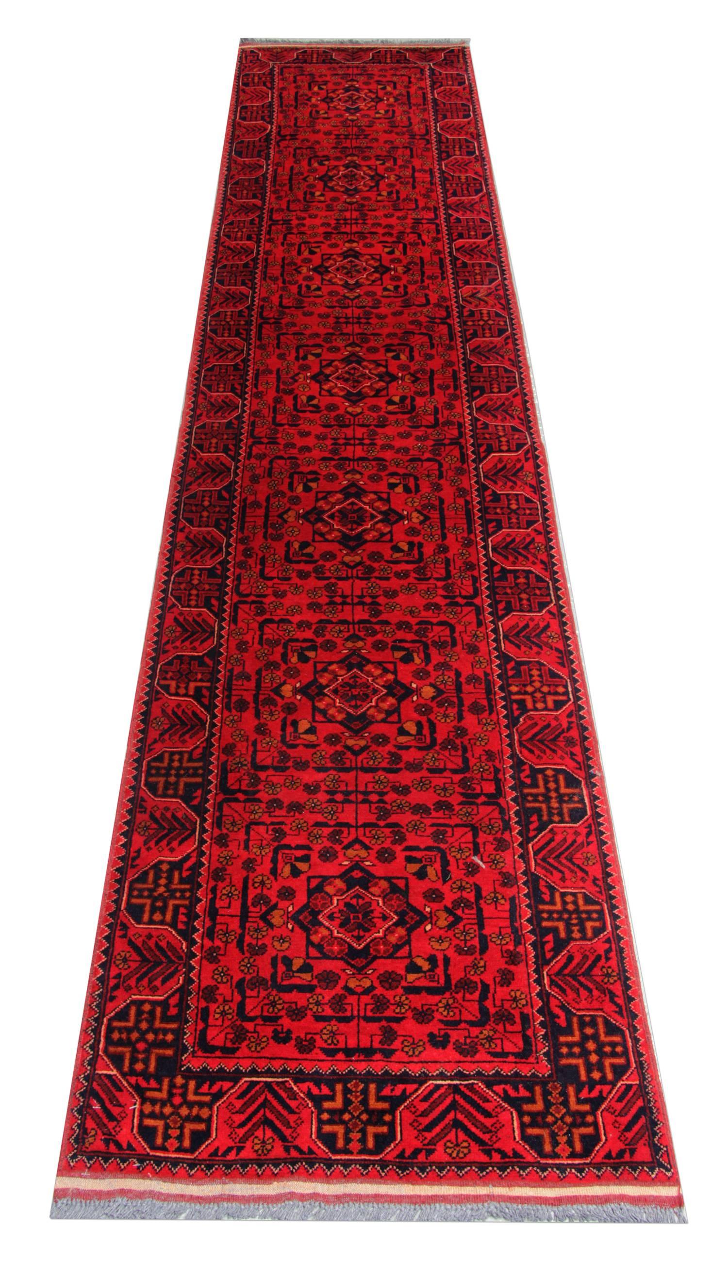 This impressive antique red rug is made from our master weavers in Afghanistan. These particular carpet runners are made with all natural vegetable dyes. The floral rug displays an all-over geometrical rug pattern. This woven rug also has an