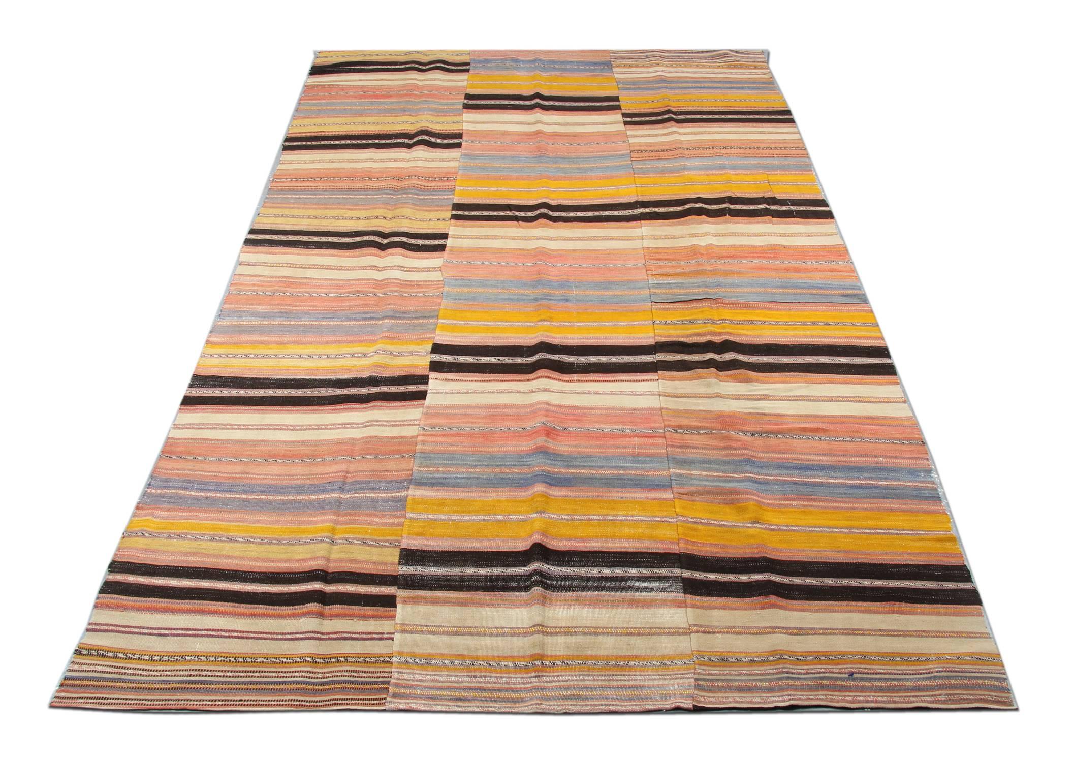 This geometric rug is a practical variation on the flat-weave Kilim, this Persian coverlet, or Jajim, features a bold, inherently versatile pattern of multi-width stripes perfectly on the woven rug suited for Mid-Century modern interiors. Ochre and