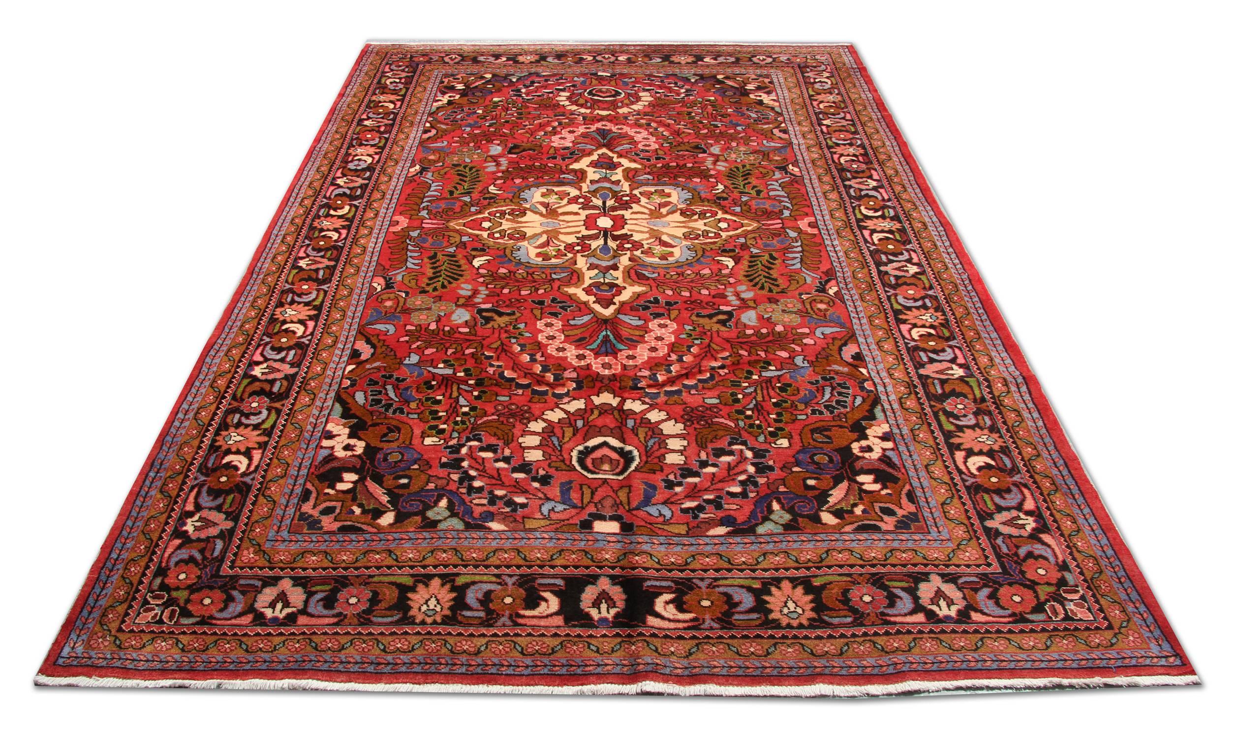 This oriental wool rug has been woven with a highly-decorative, symmetrical floral design. Woven with a fantastic color palette including a red background with, pink, blue, ivory and beige accent colours. This is then framed by a decorative repeat