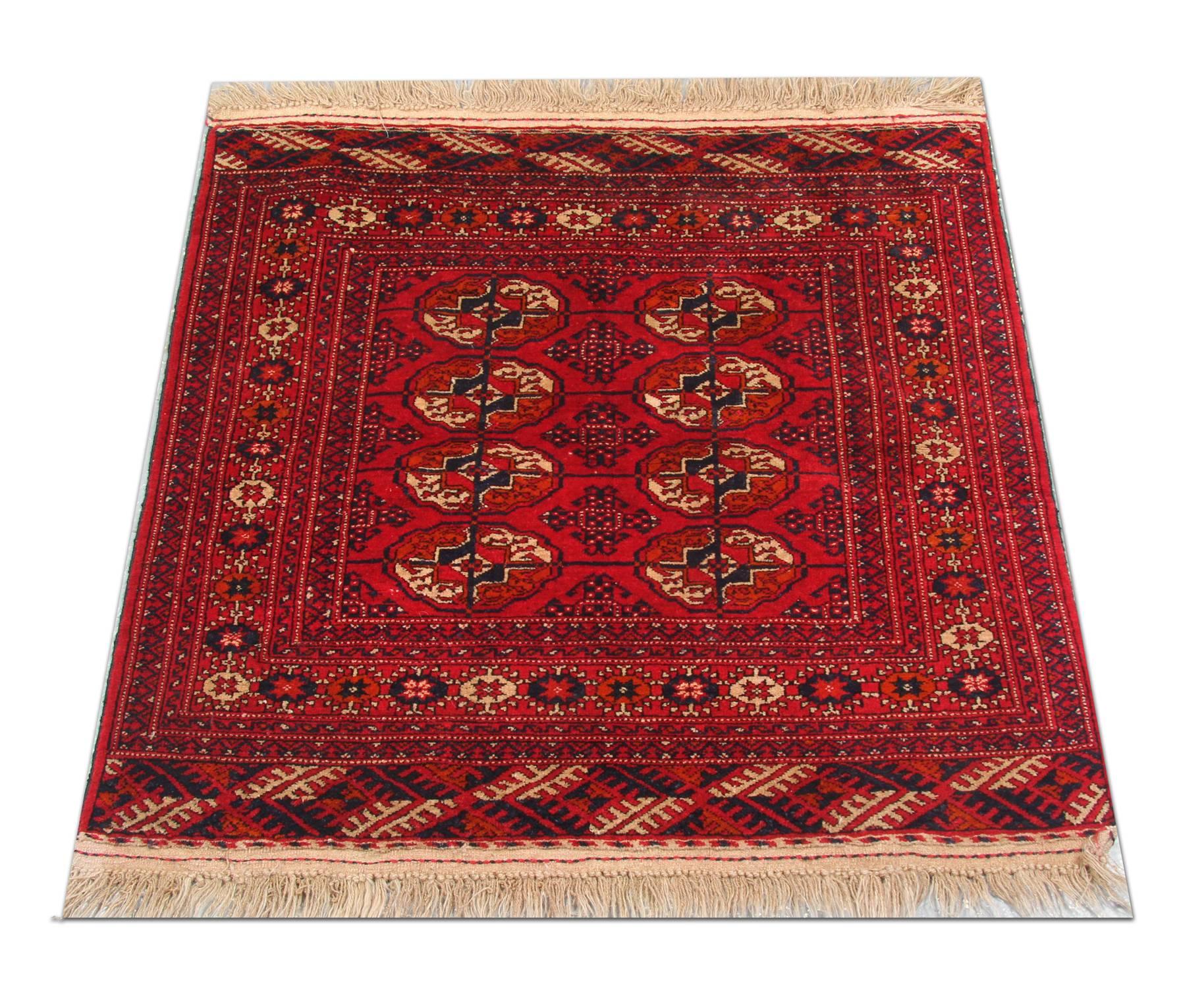 A rich red background is a field for the symmetrical oriental design woven by hand. The central medallions are intricately woven with cream, black and brown accents. A decorative repeat pattern has then framed this. Both the color and design of this
