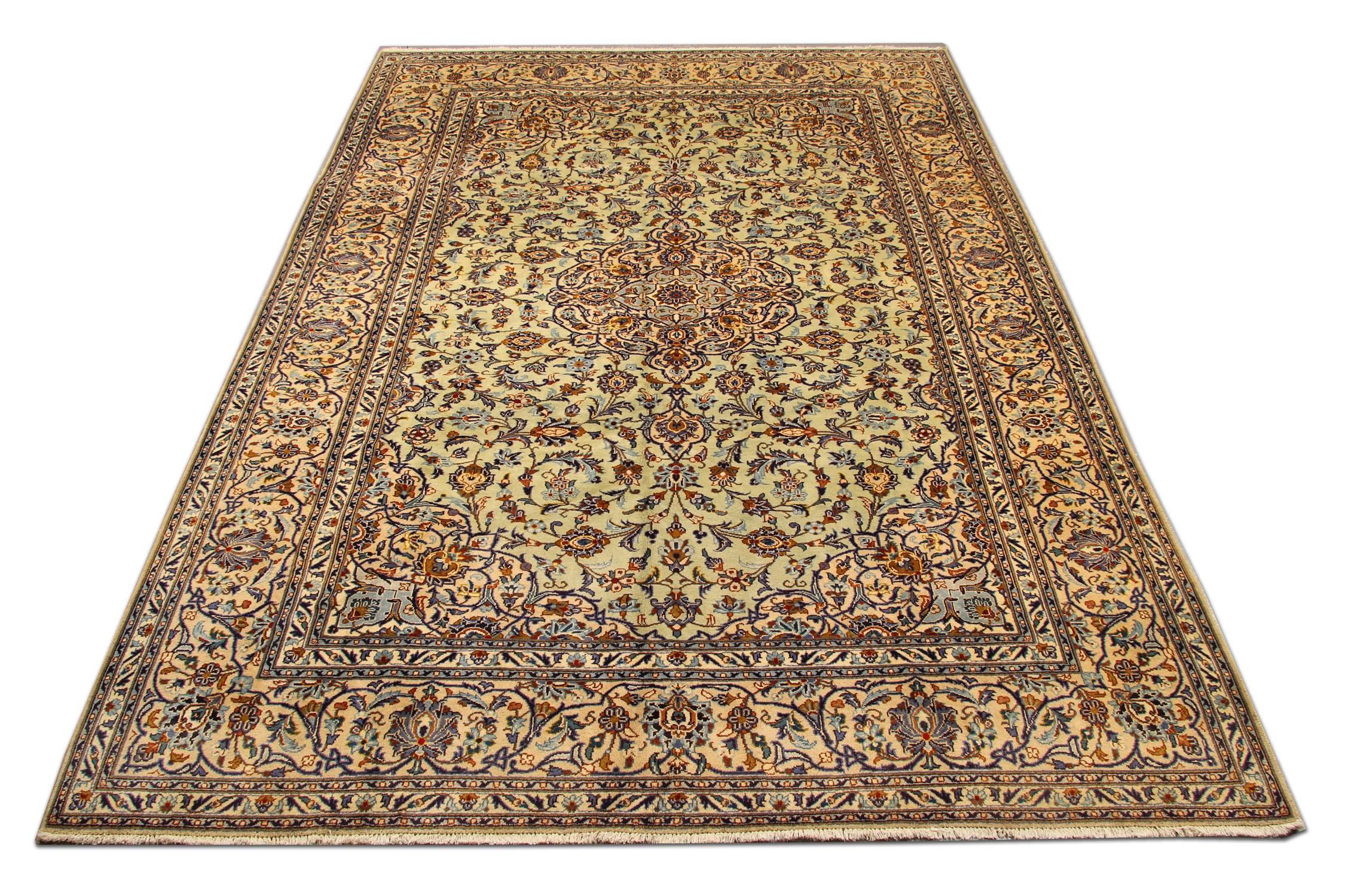 Featuring a grande central medallion and highly decorative surround design, this handwoven wool rug is sure to uplift any room. Constructed on a cream background with deep blue, beige, brown and red accent colours that make up the symmetrical floral