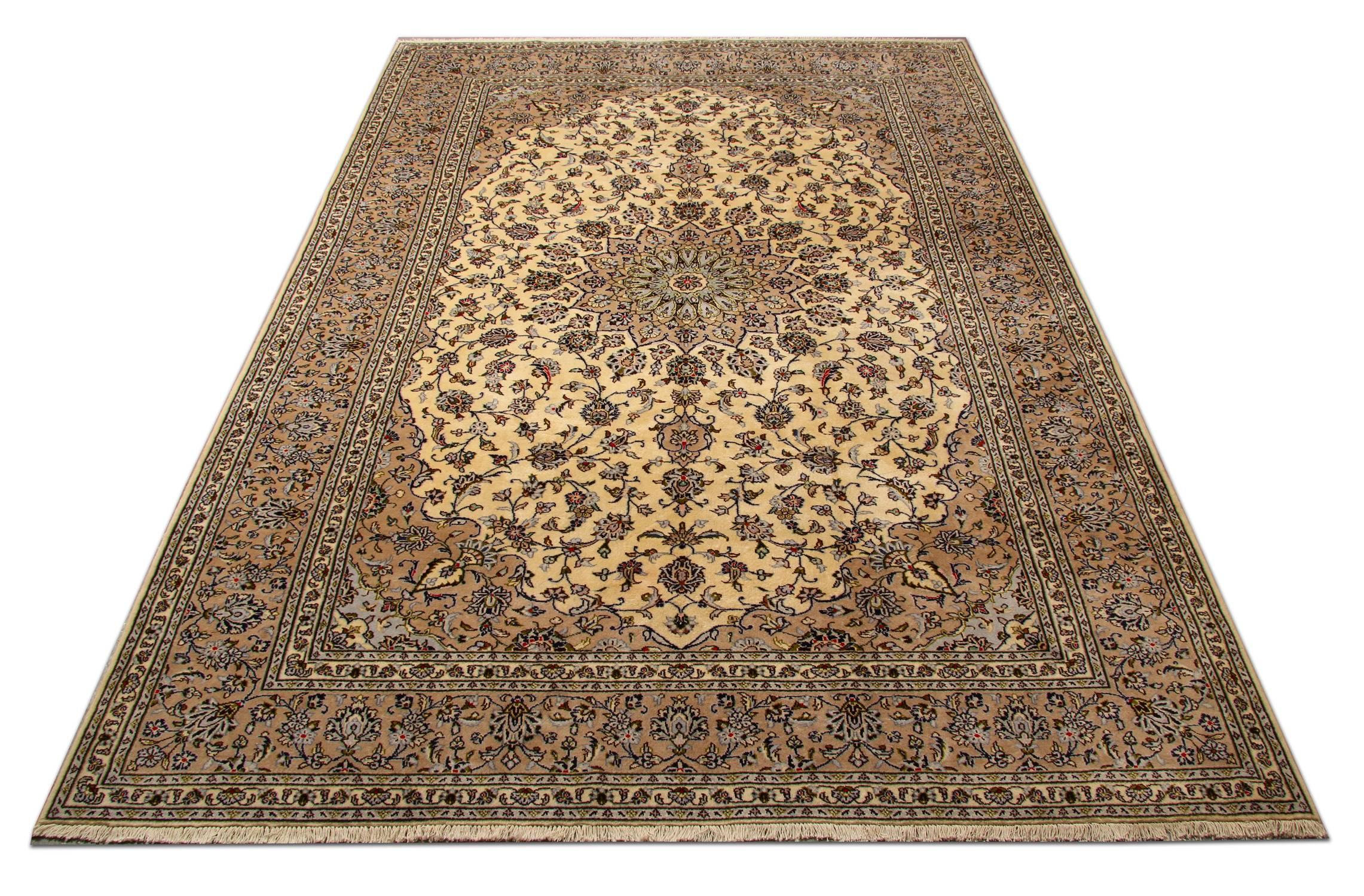 Featuring a grande central medallion and highly decorative surround design, this handwoven wool rug is sure to uplift any room. Constructed on a cream background with deep blue, beige, brown and red accent colours that make up the symmetrical floral