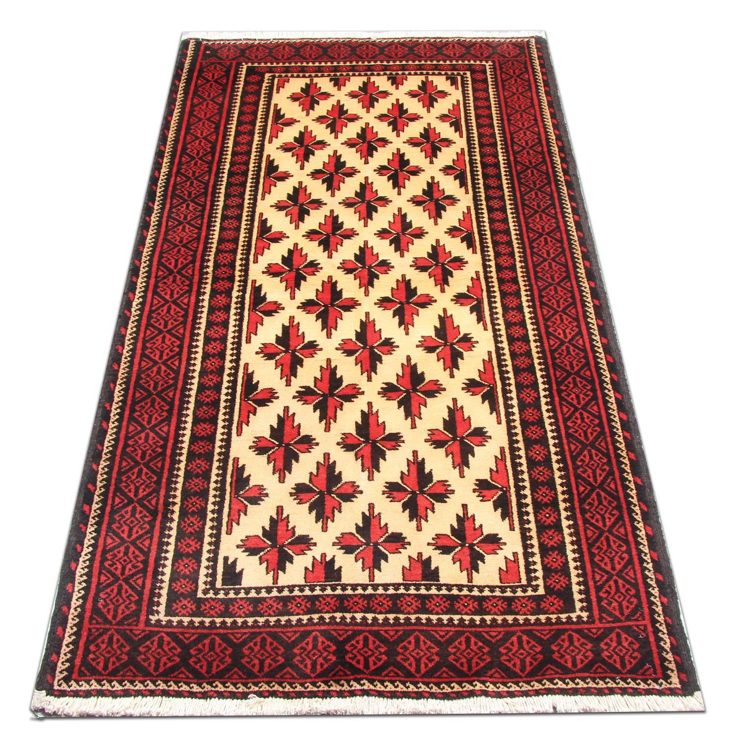 This elegant rug has been woven by hand and features a fantastic repeat pattern design woven in red and black on an ivory field. This is then enclosed by a highly-detailed repeat pattern red and blue border. This rug would make a perfect addition to
