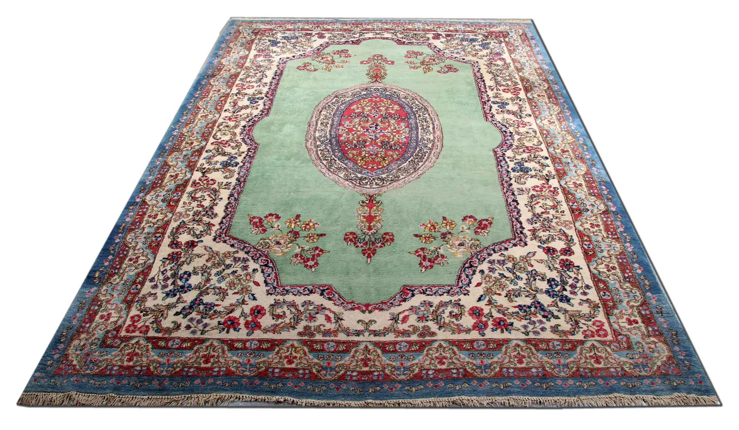 Persian Kerman rugs with light blue and orange base color rug. This rug is very magnificent and it has very nice and delightful and quiet color combination and beautifully design of medallions and flowers. Kirman is one of the most famous area in