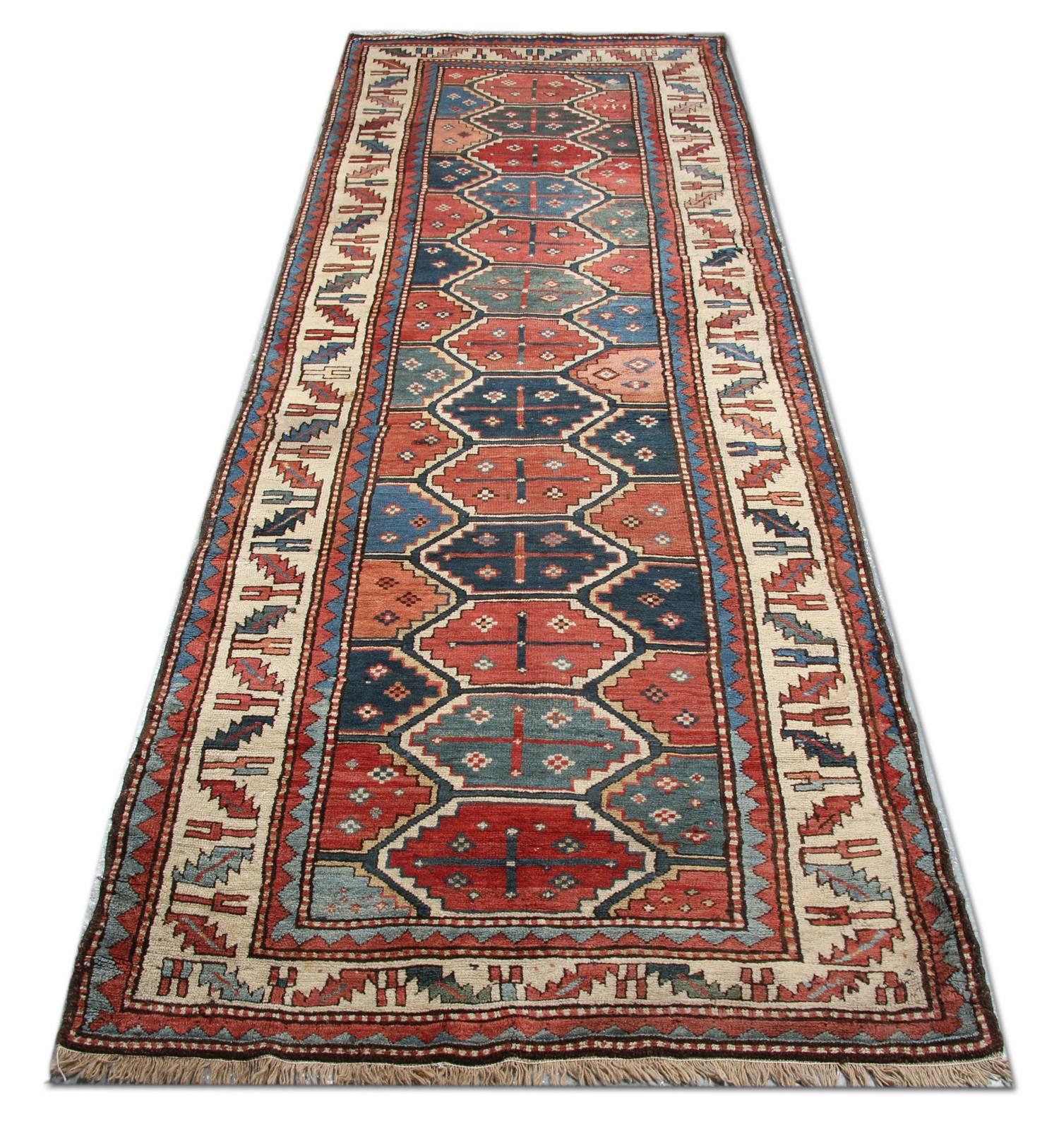 This is an antique  Kurdish with ivory colour in the border and contrasting rust salmon colour with a typical geometrical design. One can also refer to this as a Caucasian runner, circa 1890—in excellent condition.
Antique Rugs Caucasian Carpet