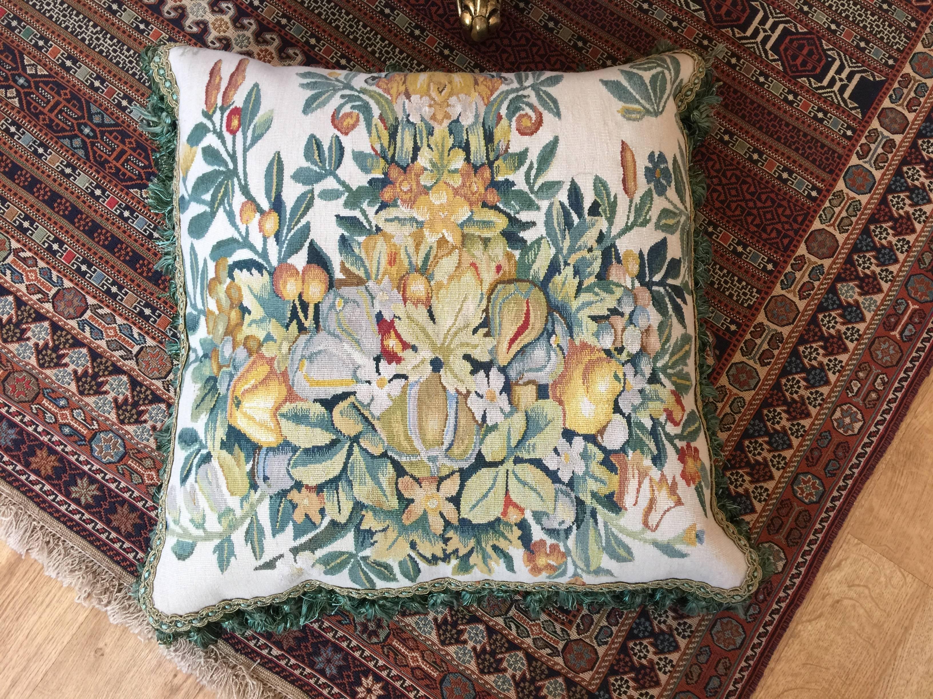 An elegant vintage French cushion cover, which is hand-made with silk and wool materials. The decorative cushion is beautifully designed with green, gold and red colors. The cushion cover is illustrating and standing out with an antique floral