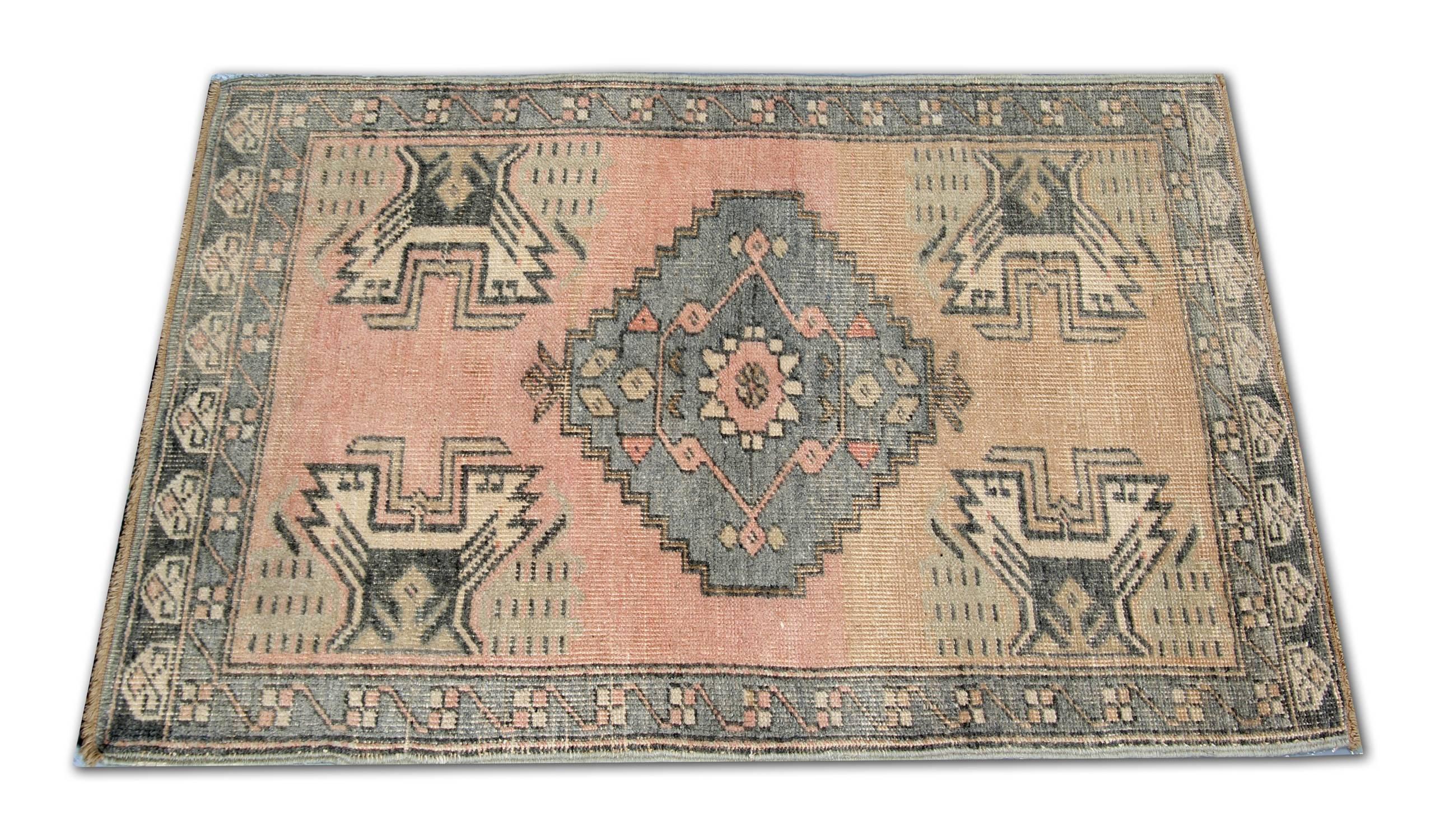 A handmade carpet vintage Anatolian carpet rug in an excellent condition. geometric rug design and a palette of nice light colours, circa the 1950s. This pink rug can be a good idea as small area rugs and is a handwoven rug with organic