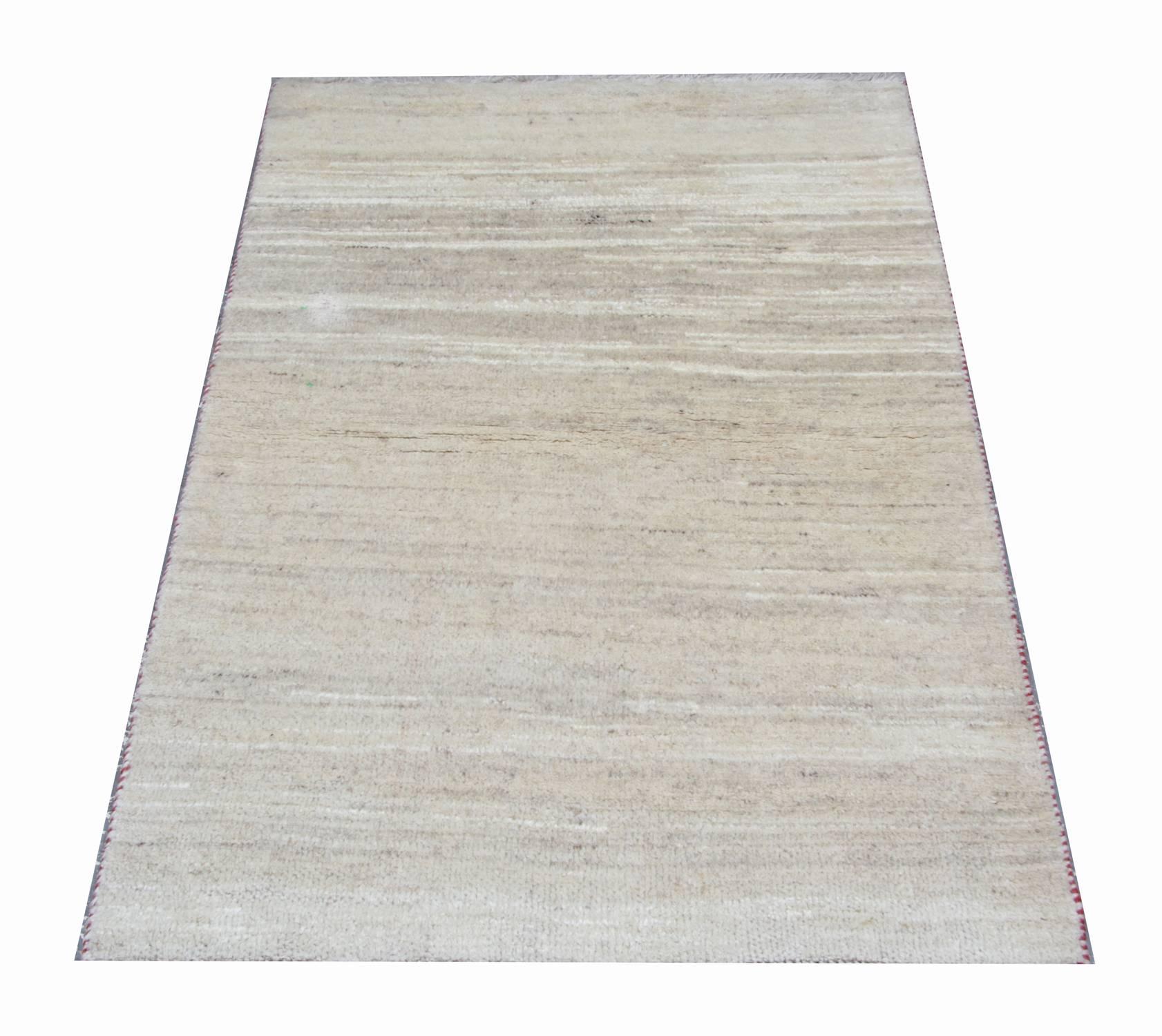 This rustic wool rug features a muted cream pallet woven in a gradient design. Simple yet sophisticated, this tasteful rug is sure to uplift any room. This rug would make a perfect addition to any home. Suitable for both modern and traditional