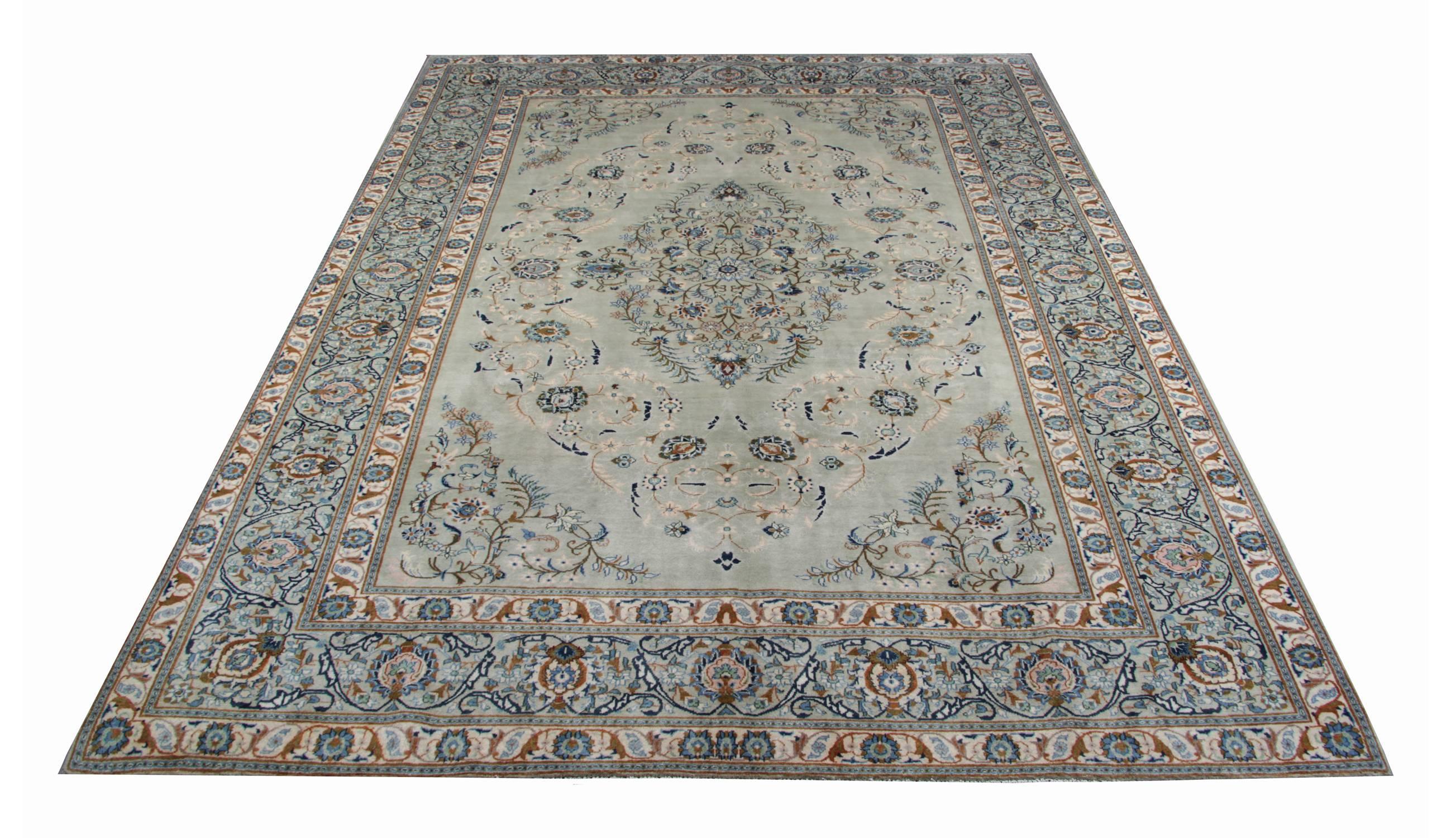 This elegant wool rug has been woven with a truly unique color pallet and fantastic design. Featuring a magnificent central medallion and surround design enclosed by a highly-detailed border. Adorned with delicate floral motifs and leafs woven in